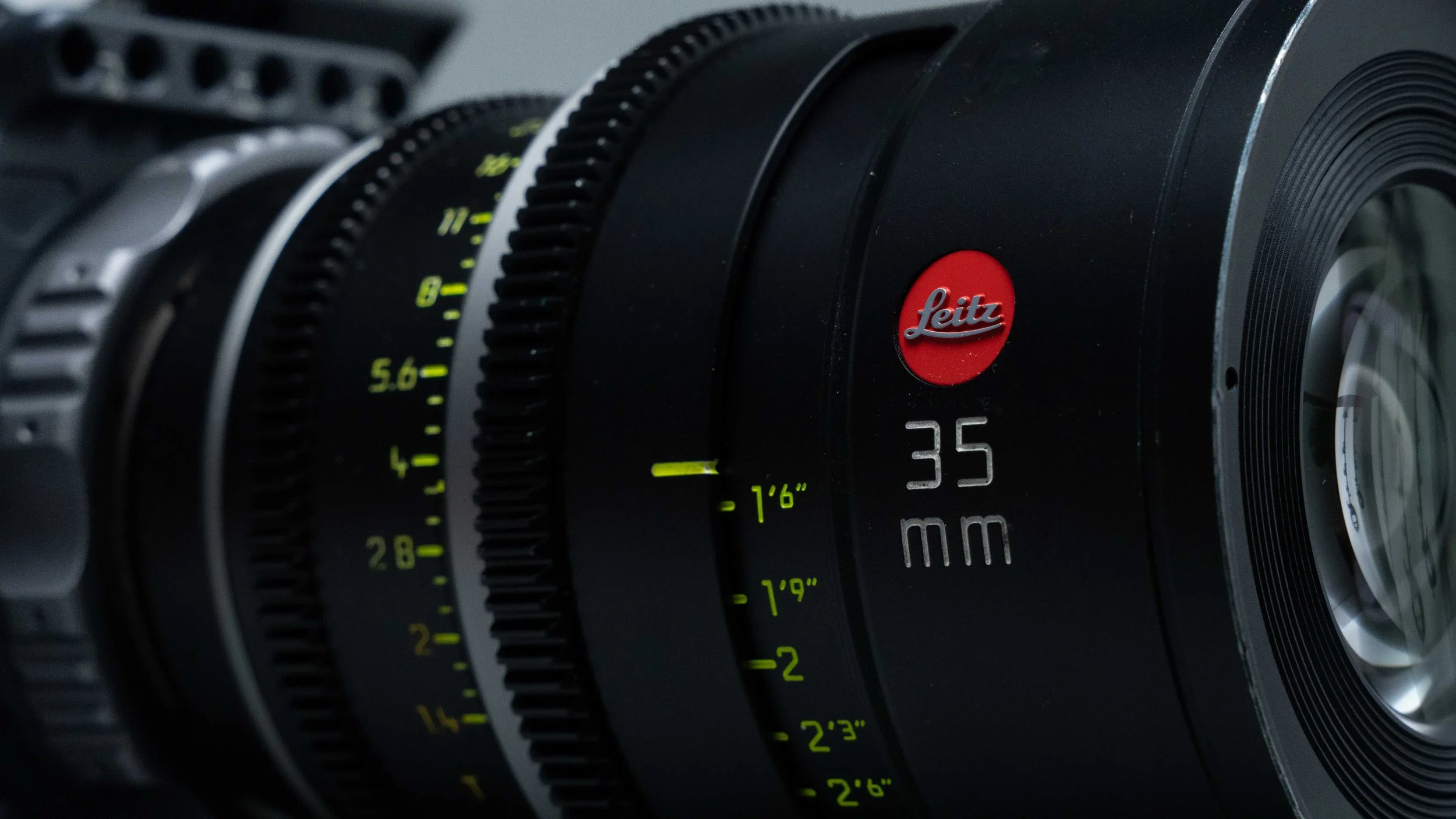 Close-up of a Leica camera lens showing focus rings, with the Leica logo and markings on the lens.