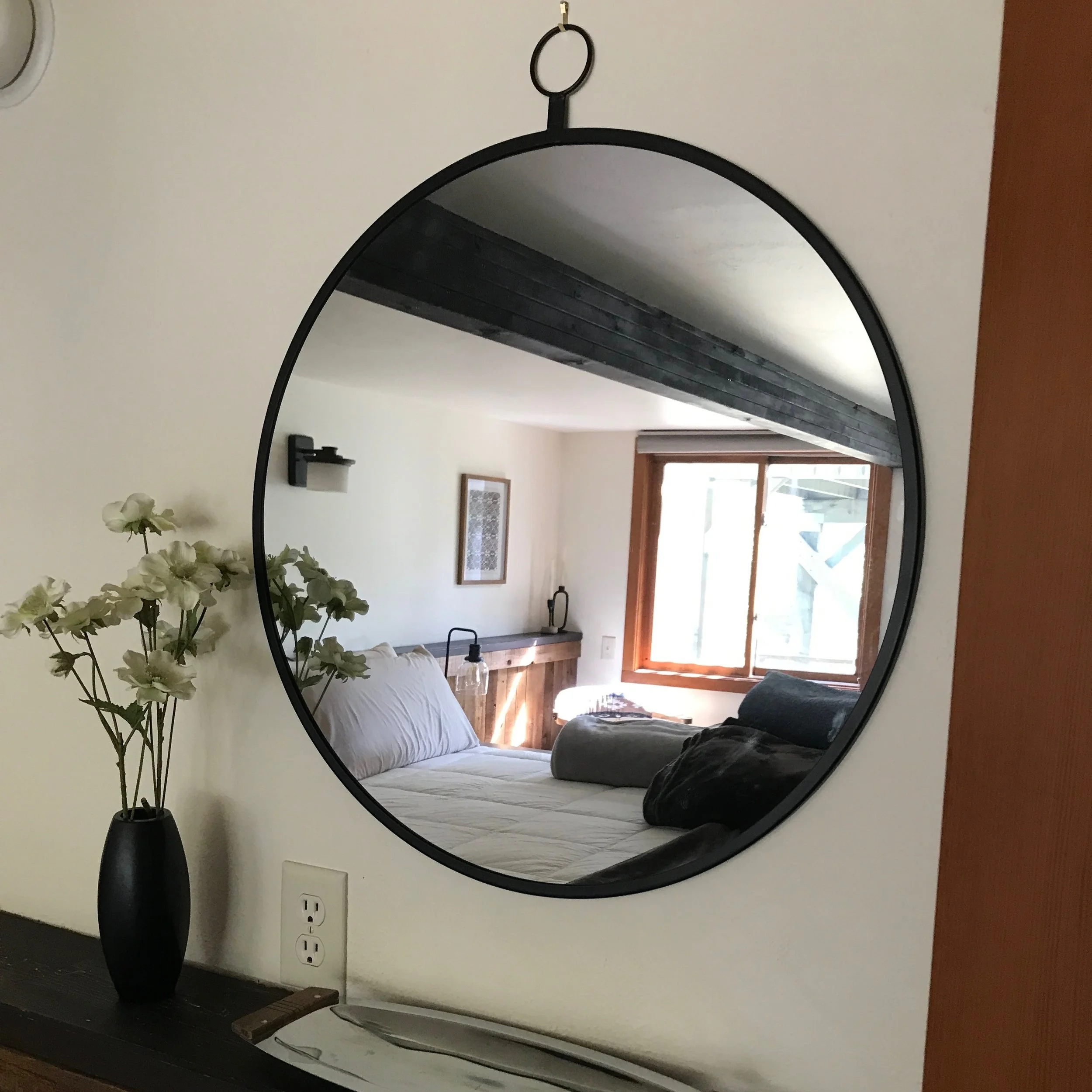mirror with bedroom in reflection