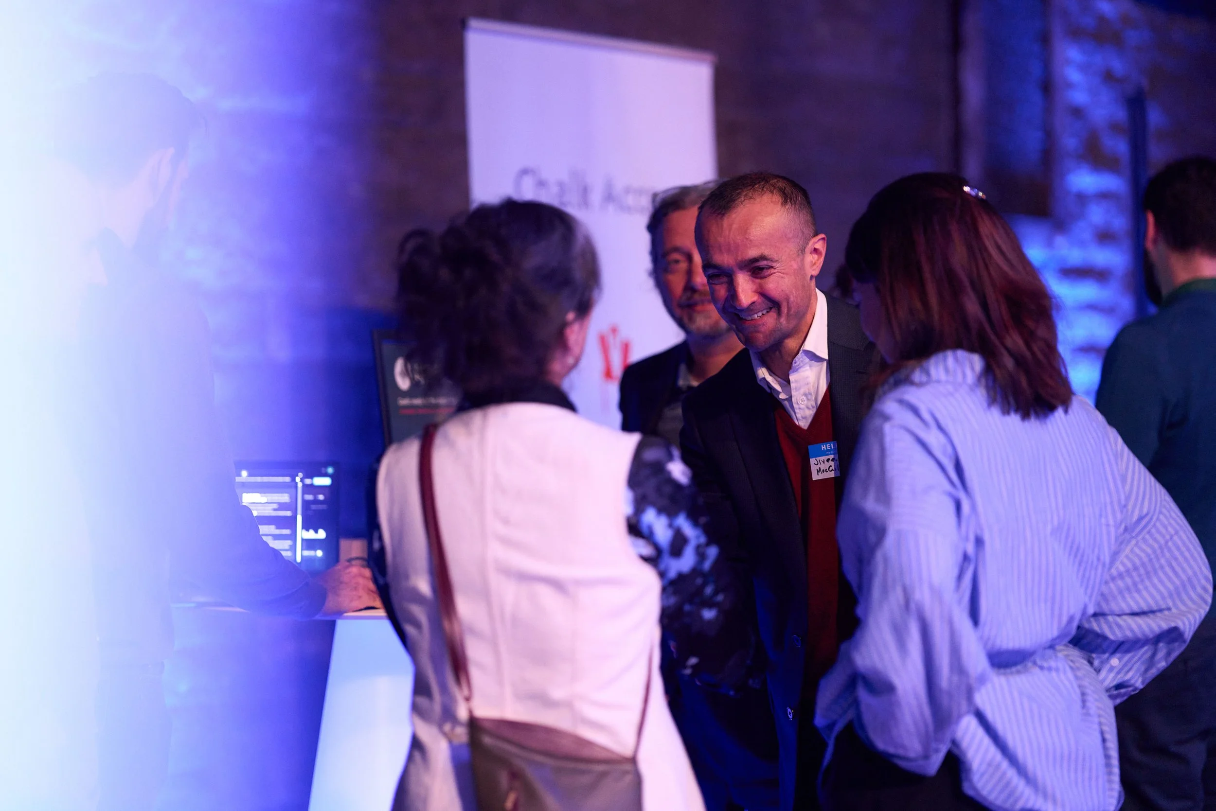 Jiveen MacGillivray, Innovation Manager, speaking with two guests at CivTech Round 11 Demo Day
