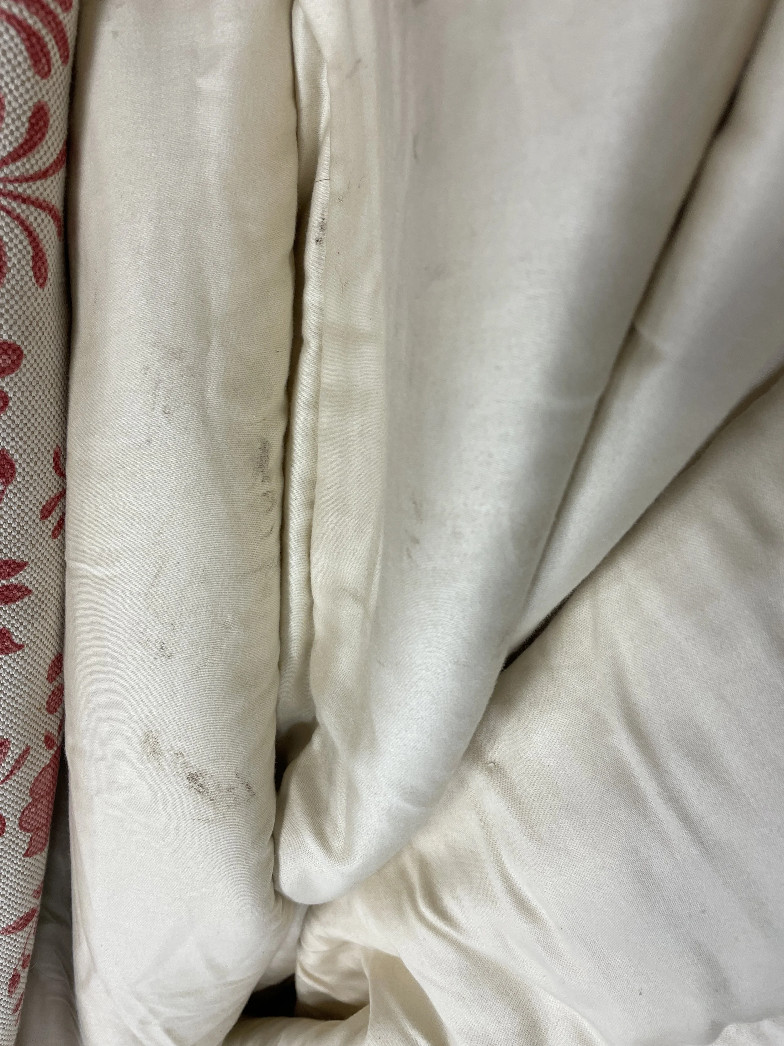 Close-up of stained white and beige fabric curtains.