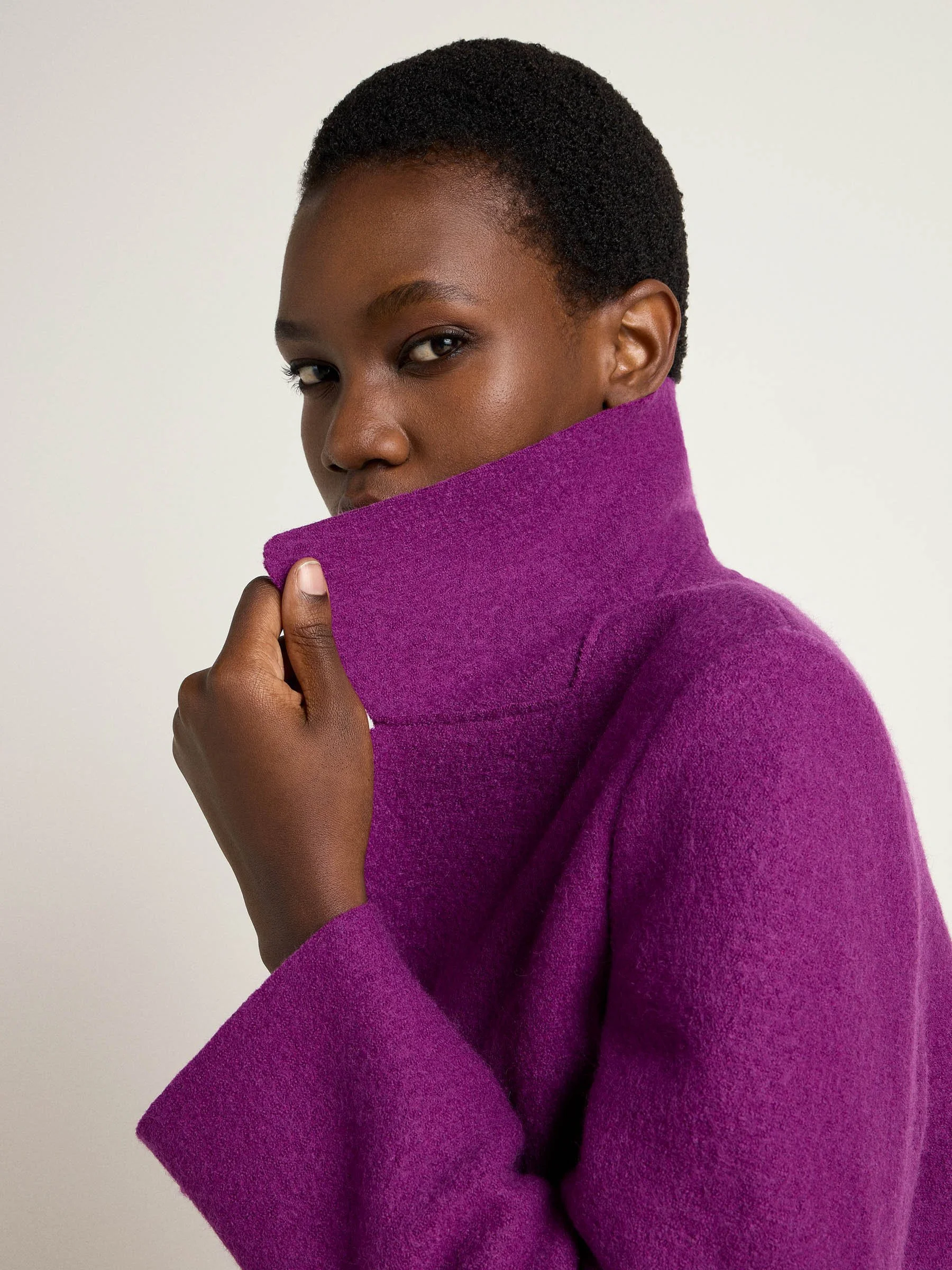 Close-up of the violet wrap coat's collar, showcasing its elegant design