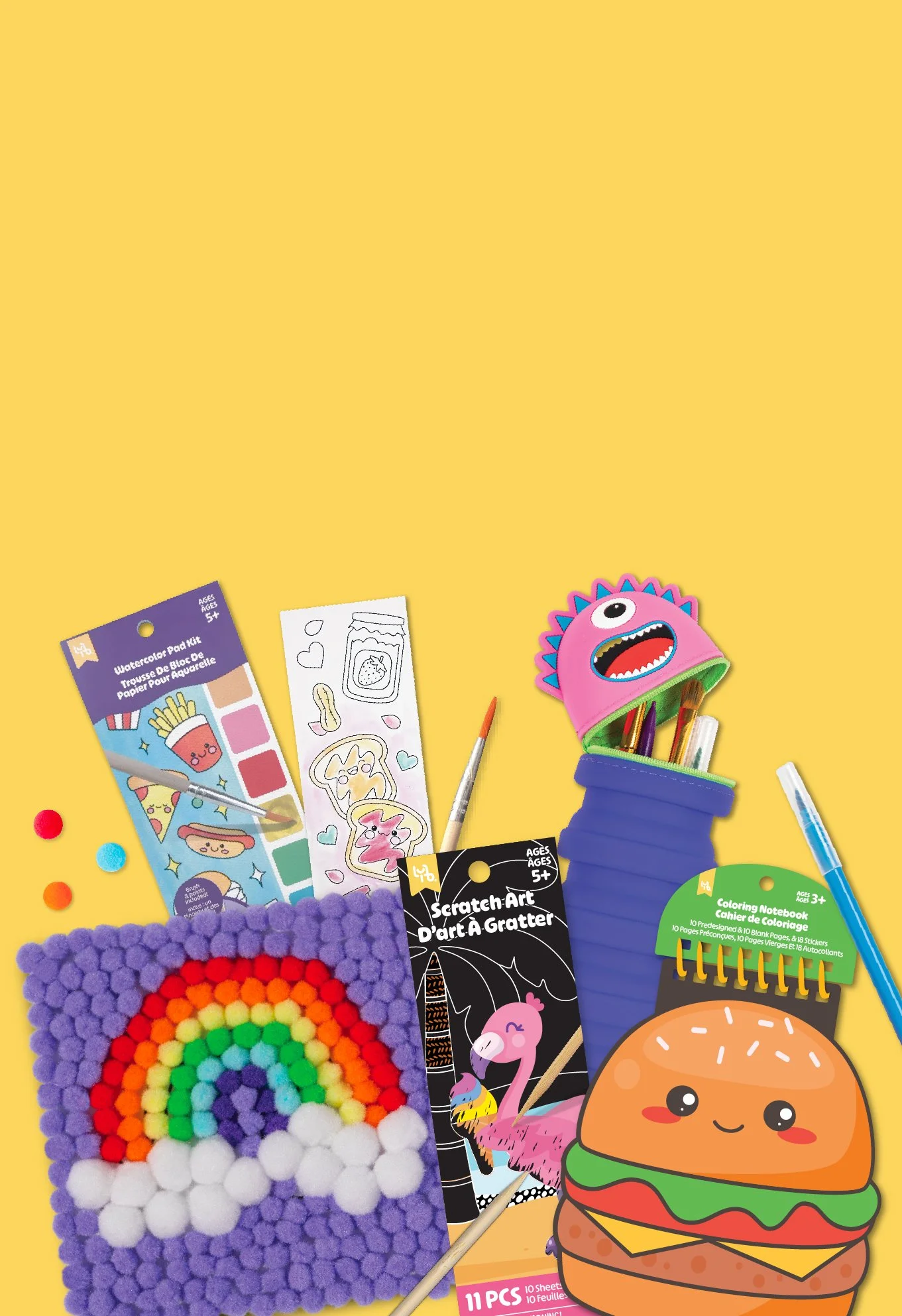 Colorful children's arts and crafts supplies on a yellow background, including a rainbow pom-pom picture, coloring pages, markers, a unicorn scratch art, a rainbow water-color kit, a burger sticker, and a pink creature-themed pencil holder with pencils inside.