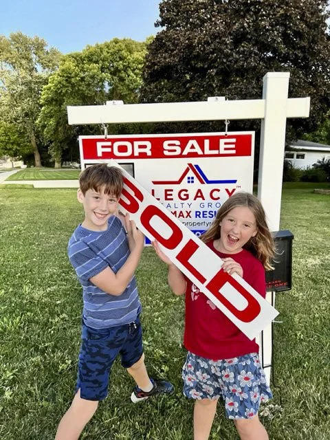 Real Estate Humor - Two kids holding sold real estate sign in Rochester Minnesota