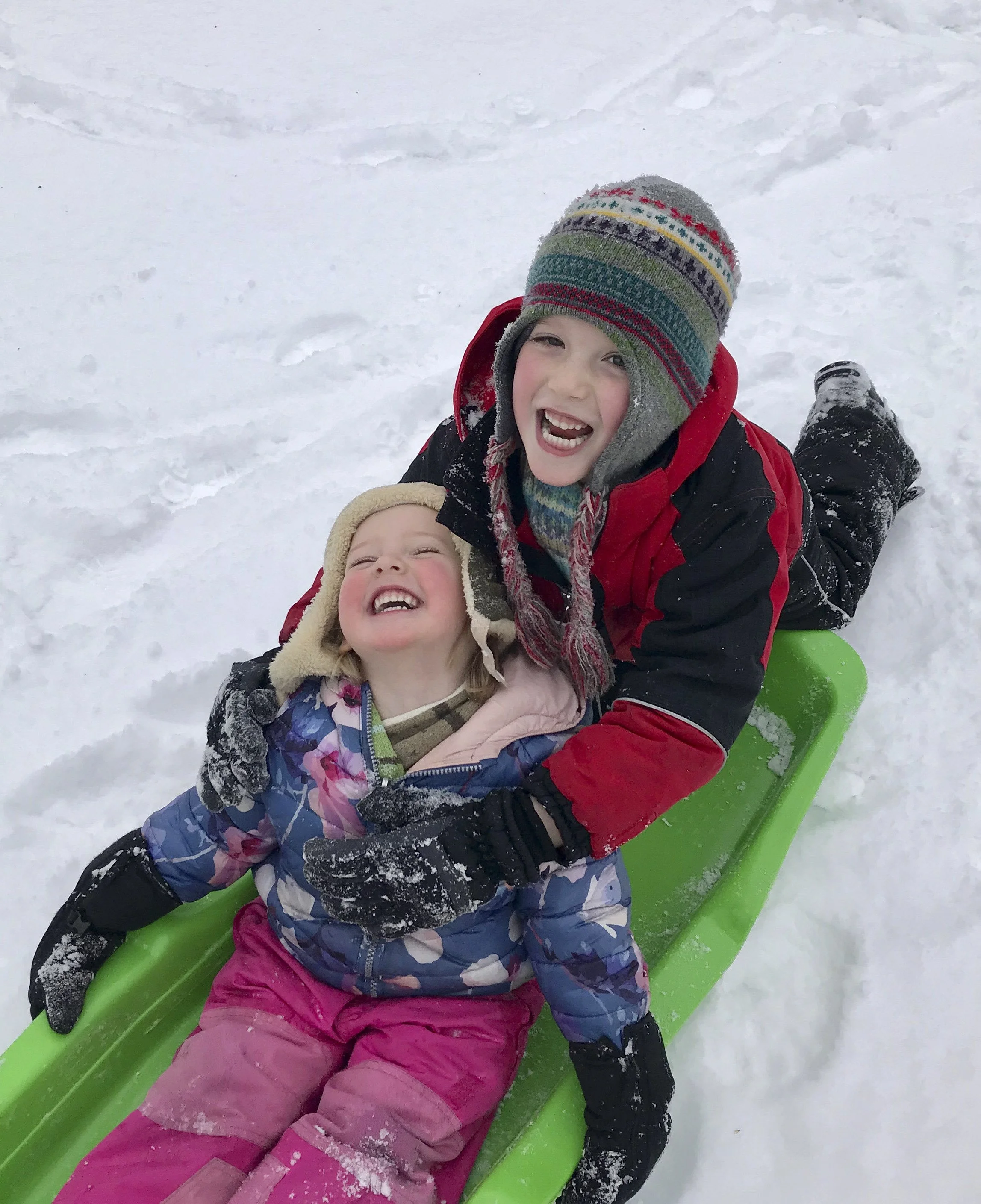 Kids winter activity. Kids sledding and laughing. Real Estate website Sandra Reid Remax Results. Things to do with kids guide