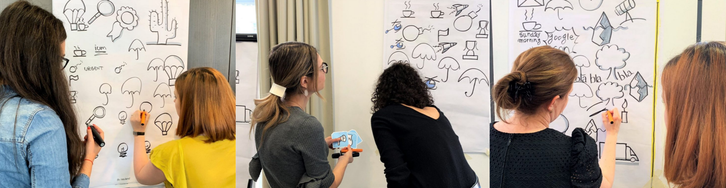 Group of women drawing and brainstorming on large sheets of paper with icons and sketches in a meeting room.