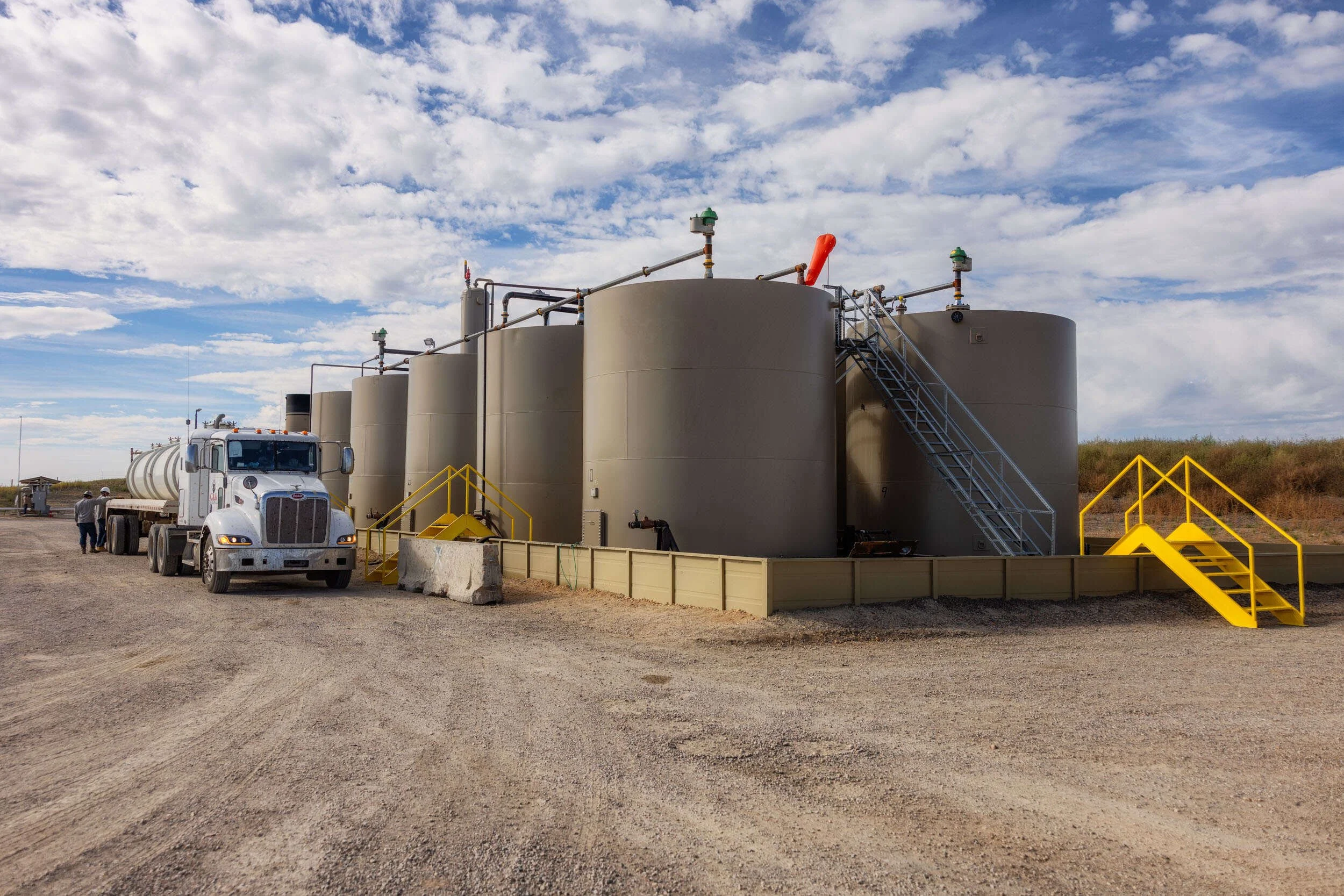 Tanker truck at tank battery station.