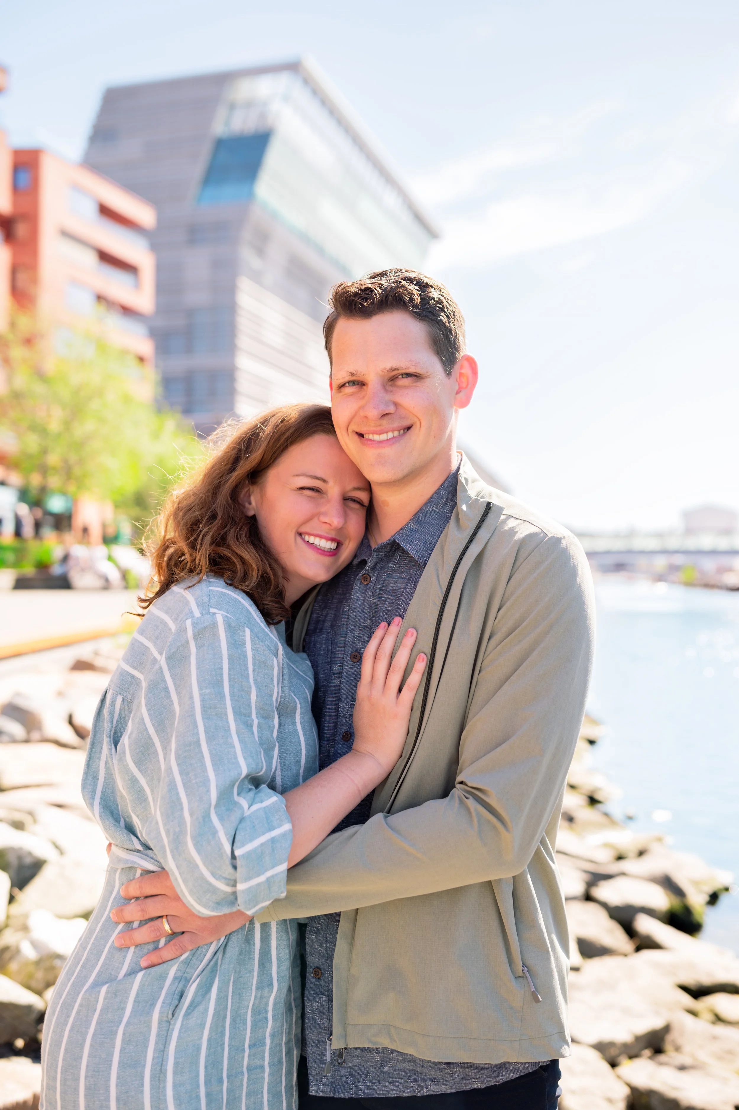 Couple hugging and standing in front of the Munch Museum in Oslo.