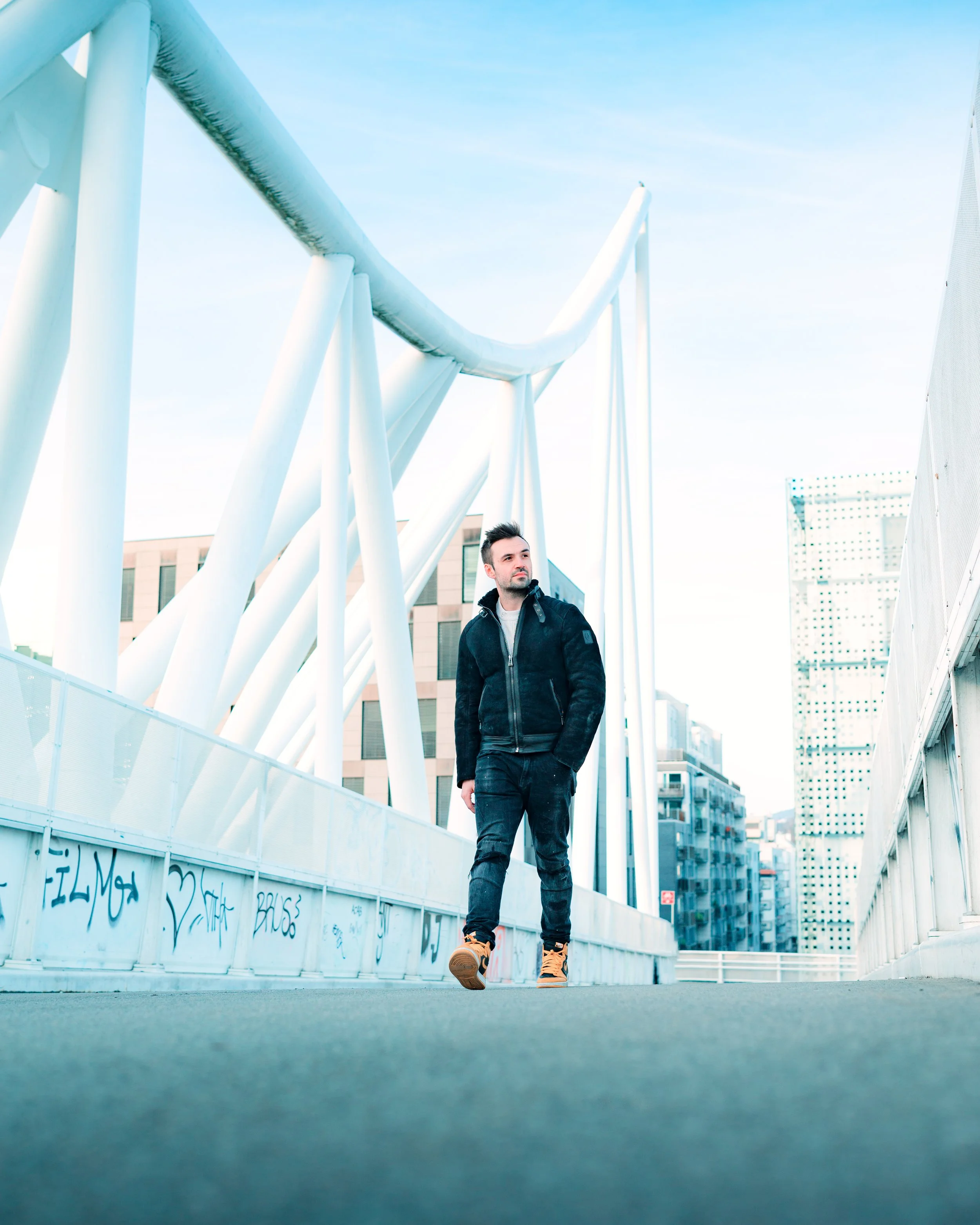 man walking down a bridge in Oslo