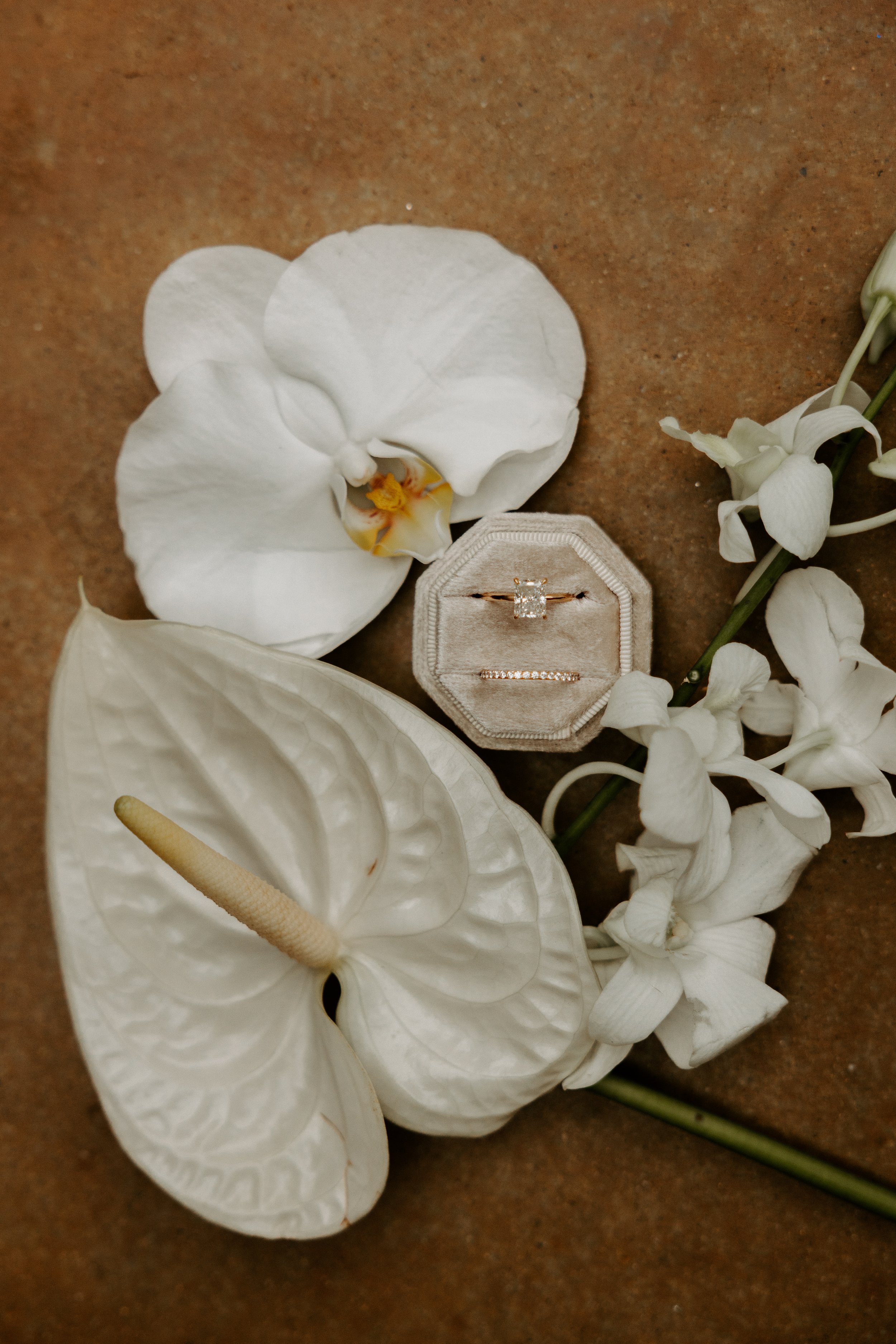 White flowers and engagement ring in box