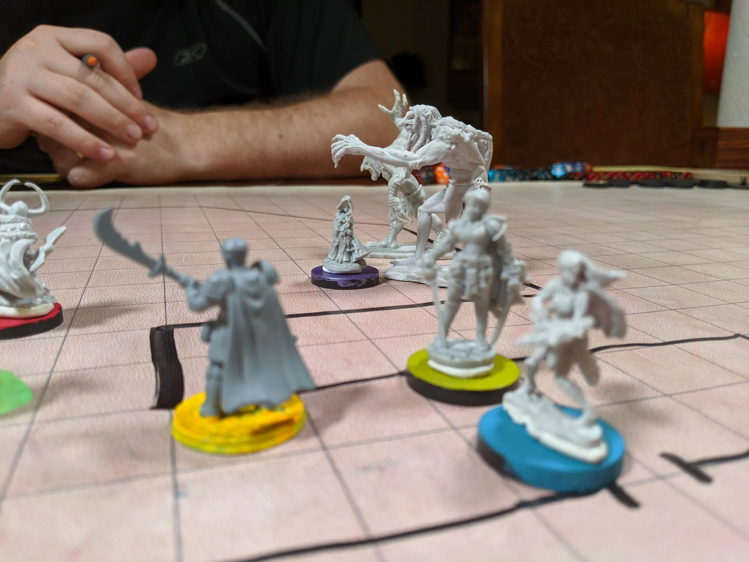 battle map with seven miniatures representing characters engaged in battle