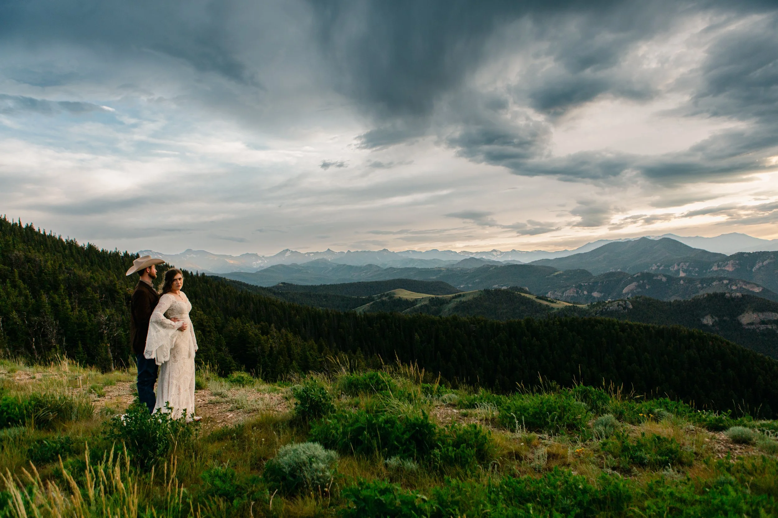 Couple overlooking mountains during backcountry elopement in Montana