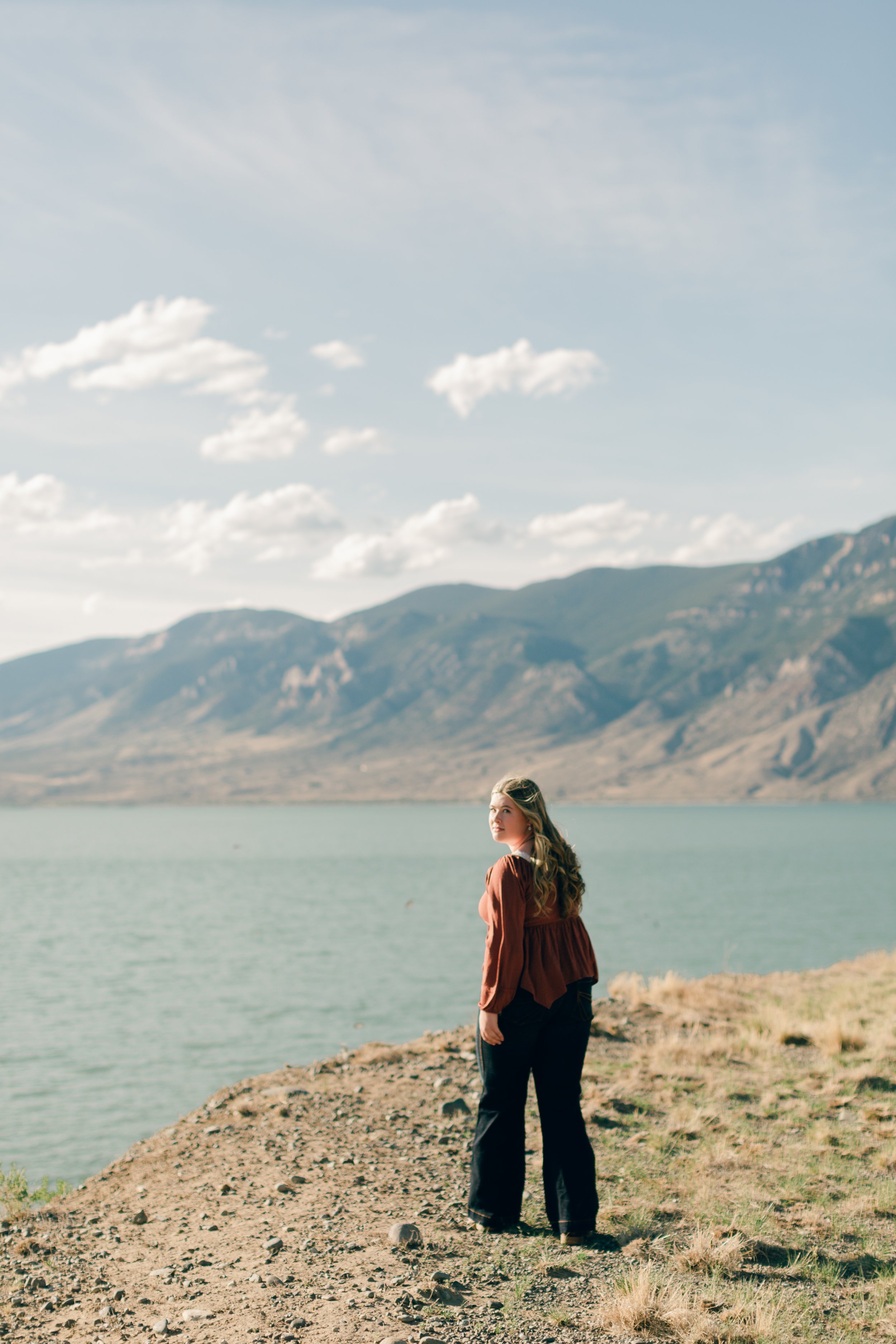 Senior portrait overlooking Buffalo Bill Reservoir during an evening photography session near Cody, Wyoming.