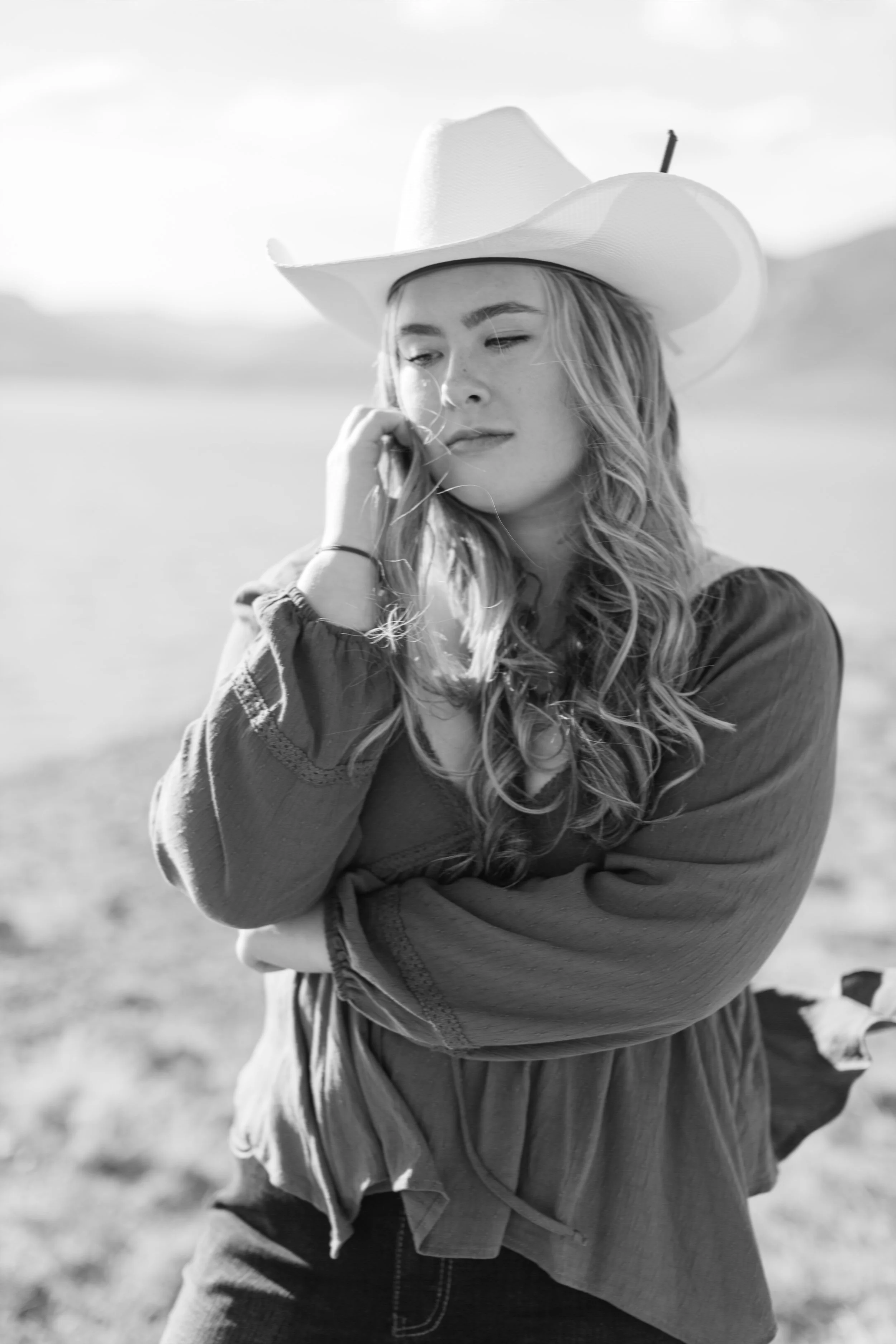 Black and white western senior portrait near Cedar Mountain outside Cody, Wyoming.