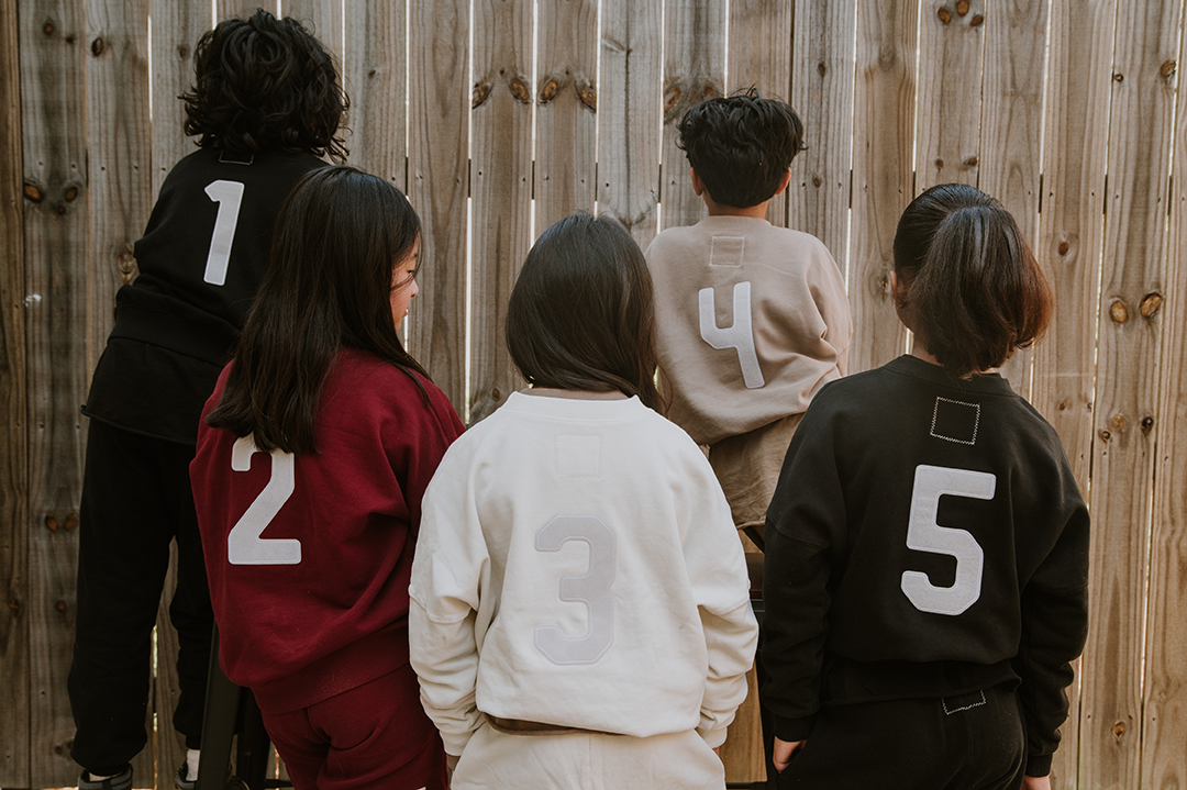 positionless by Kristen Ledlow is inspired by her love of basketball and professional career with the NBA created by creative agency BTS Group founder Ryan McGrath. Vintage varsity gender neutral kids streetwear organic cotton hoodies, t shirts