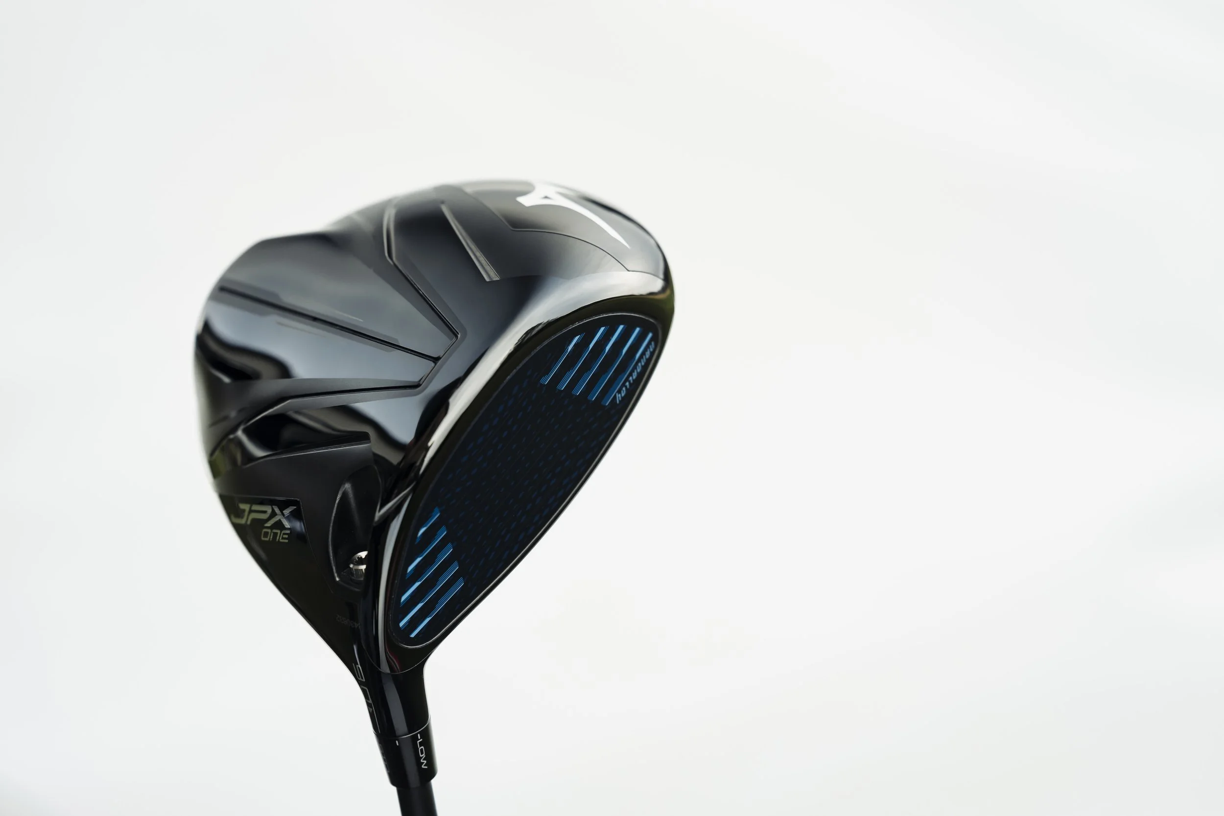 Close-up of a modern golf driver club head with black and blue accents.