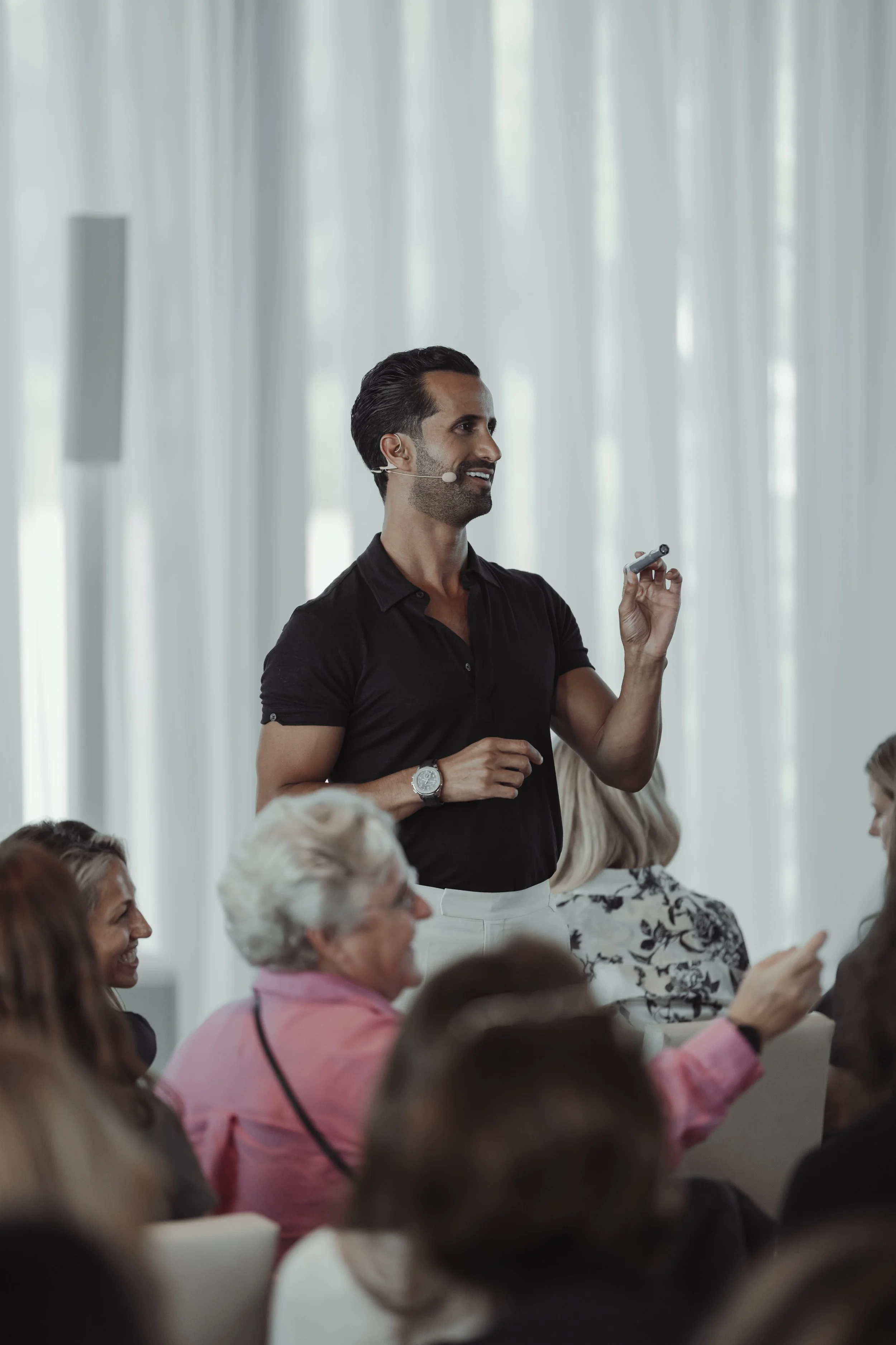 A man giving a presentation to an audience in a conference room.