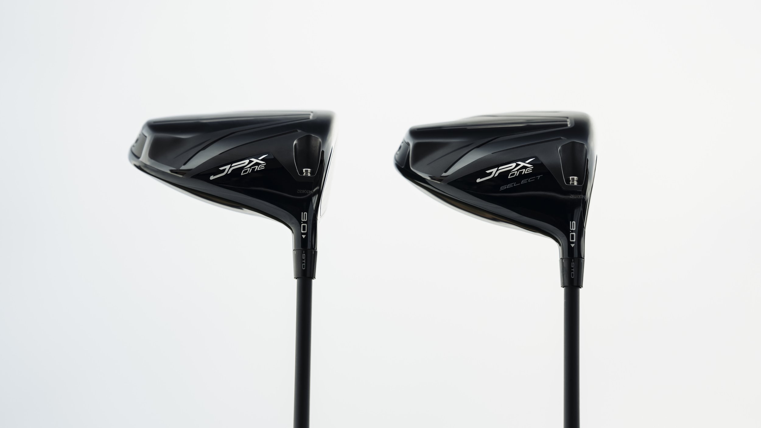 Two black Nike JPX one golf drivers facing toward the right, with white background.