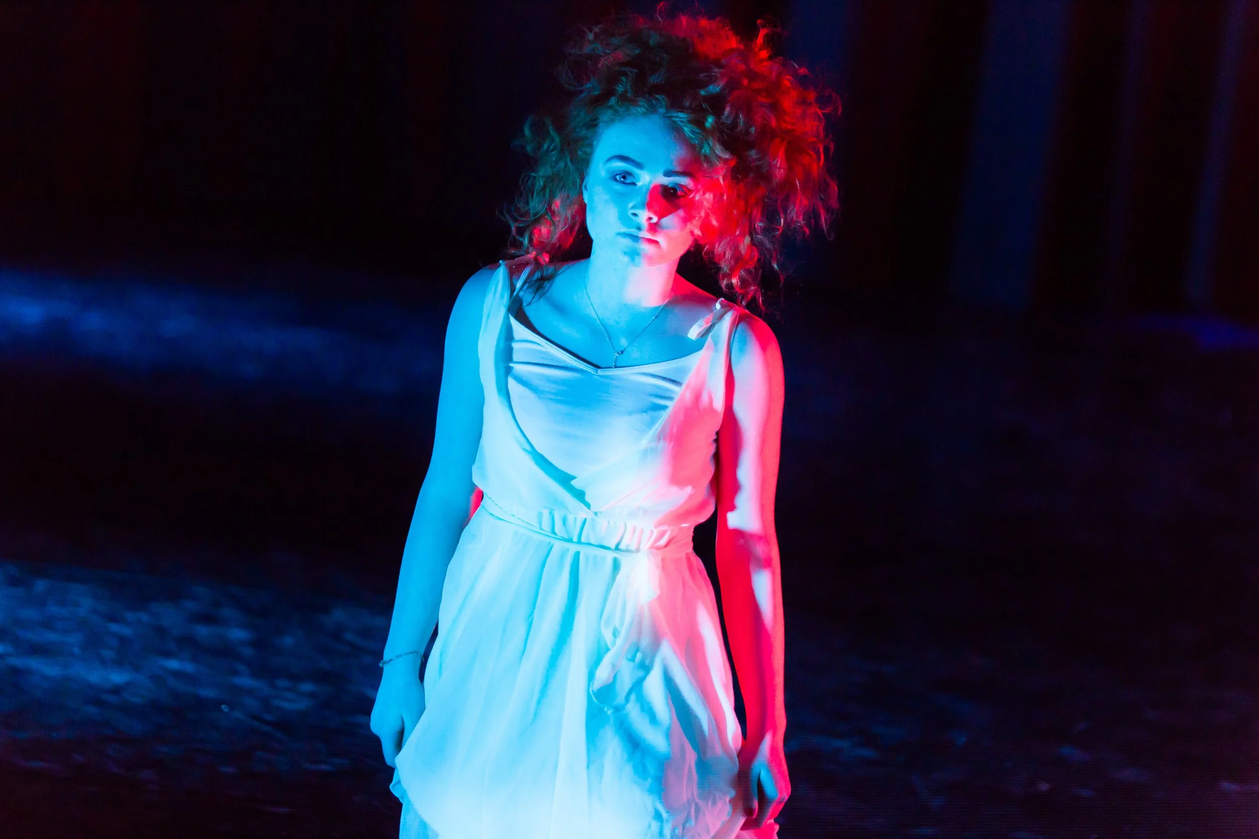 Image of a dancer cast in white light.