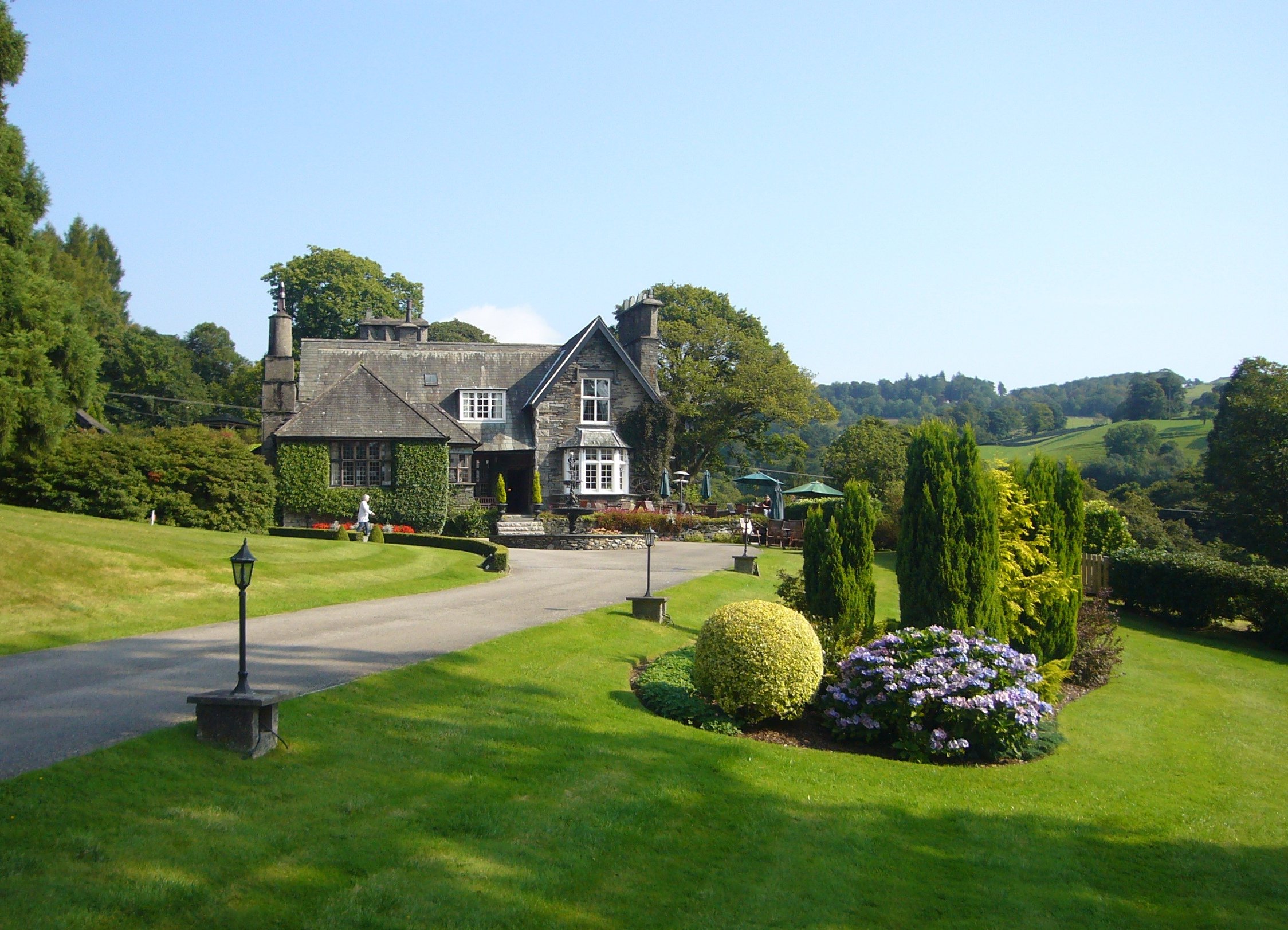 Historic stone house with greenery and gardens