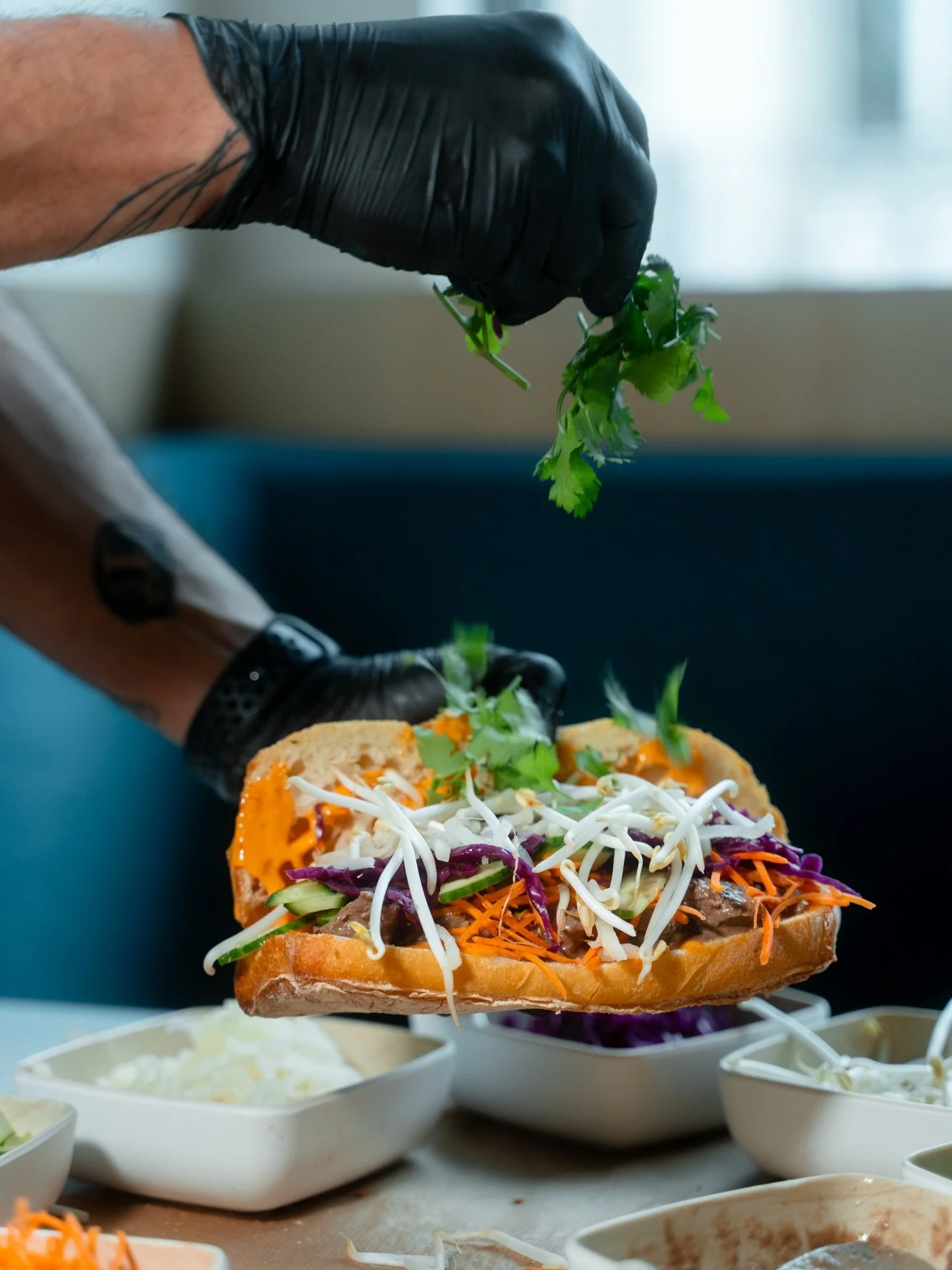 A Banh Mi isn&rsquo;t finished until the fresh herbs hit the top. It&rsquo;s that last layer of flavor that brings the whole sandwich to life.