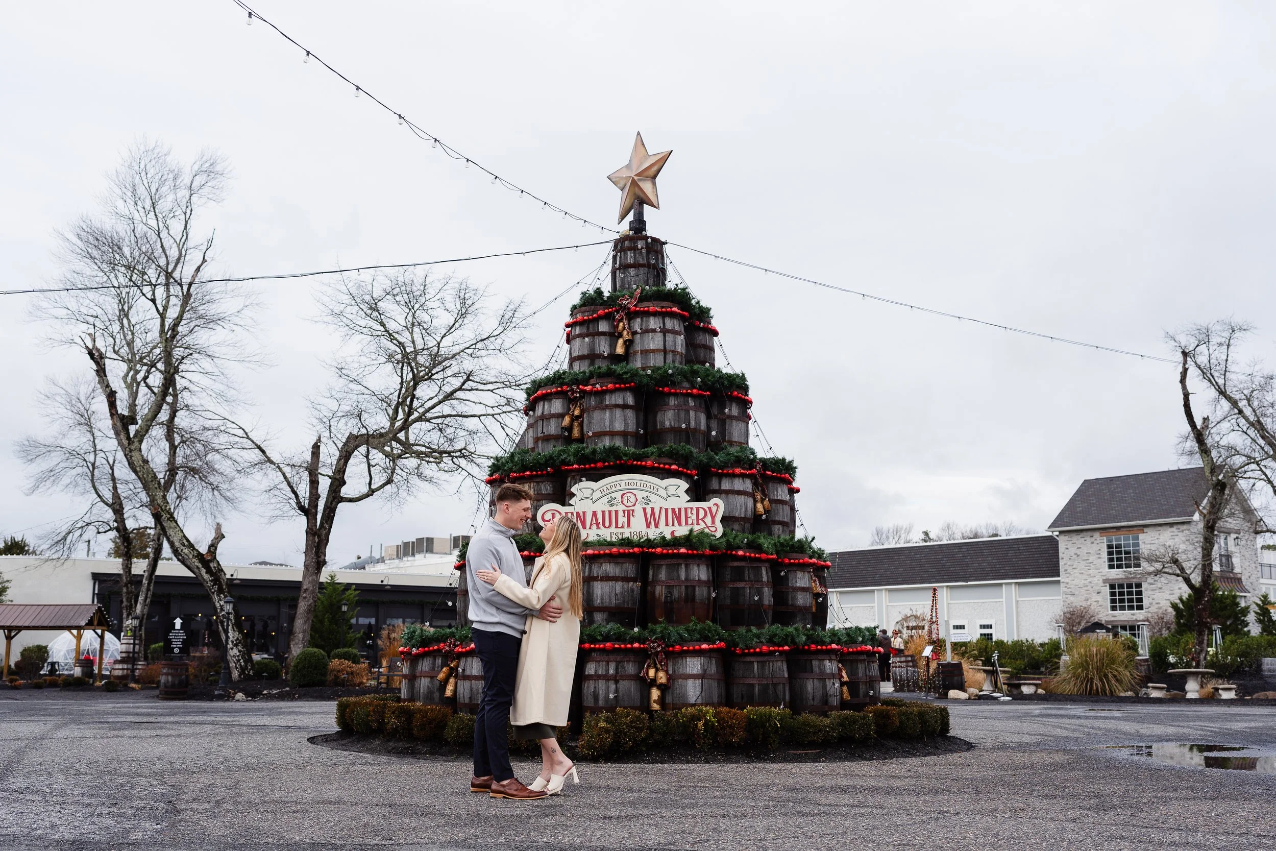 Couple embracing in front of barrel display at Renault Winery in Egg Harbor New Jersey.