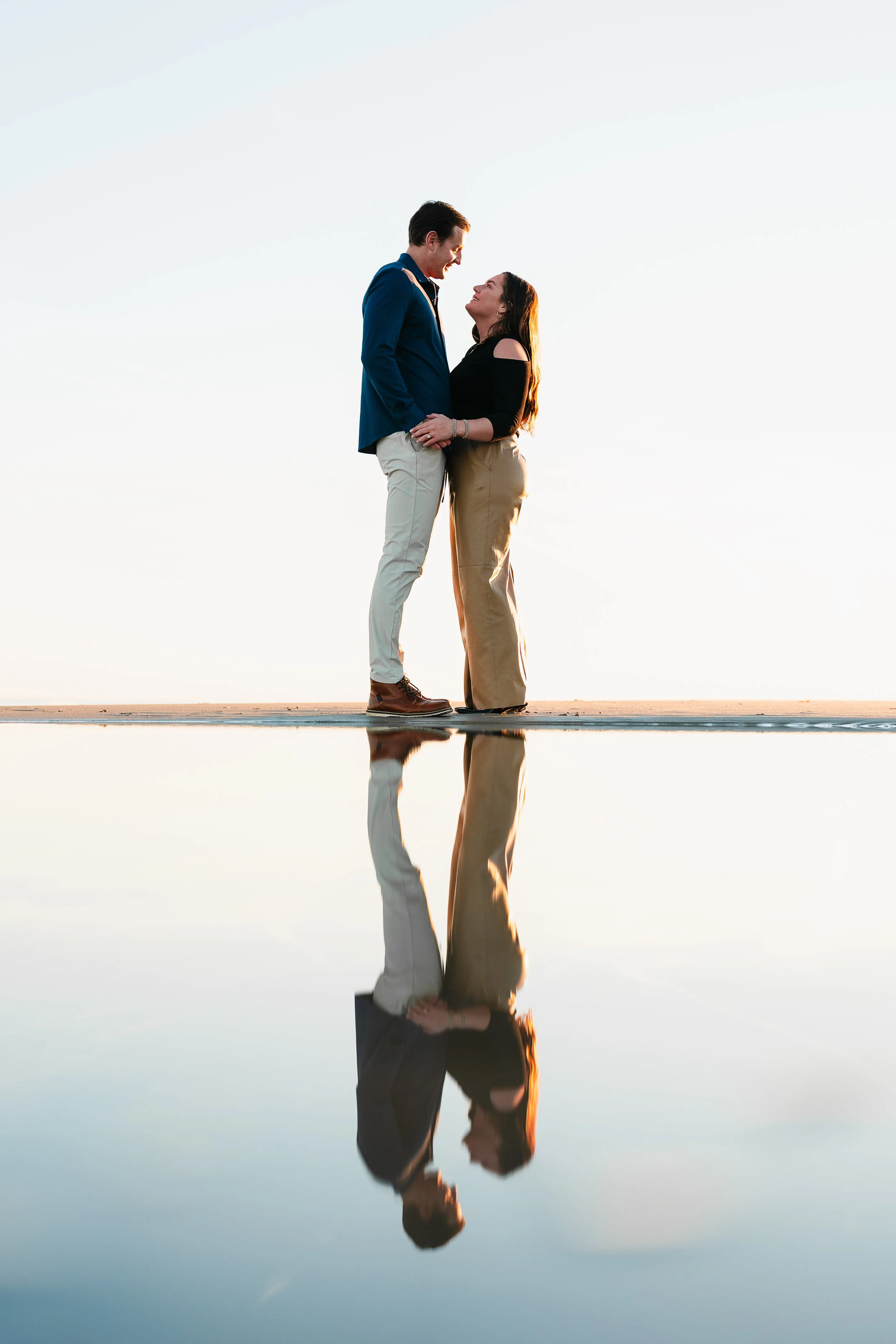 Couple Embracing with reflection in the water on the beach. Brigantine New Jersey, near by Atlantic City