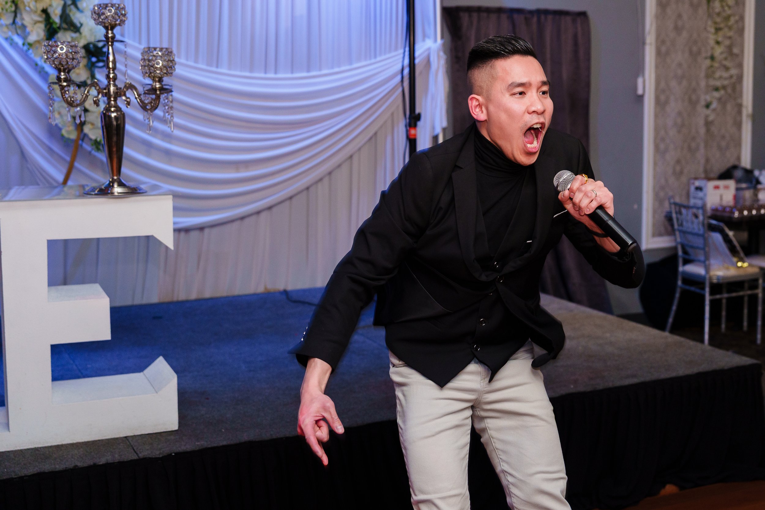 Best Man giving high energy speech during wedding reception at Asian Palace Restaurant in Philadelphia, PA. 
