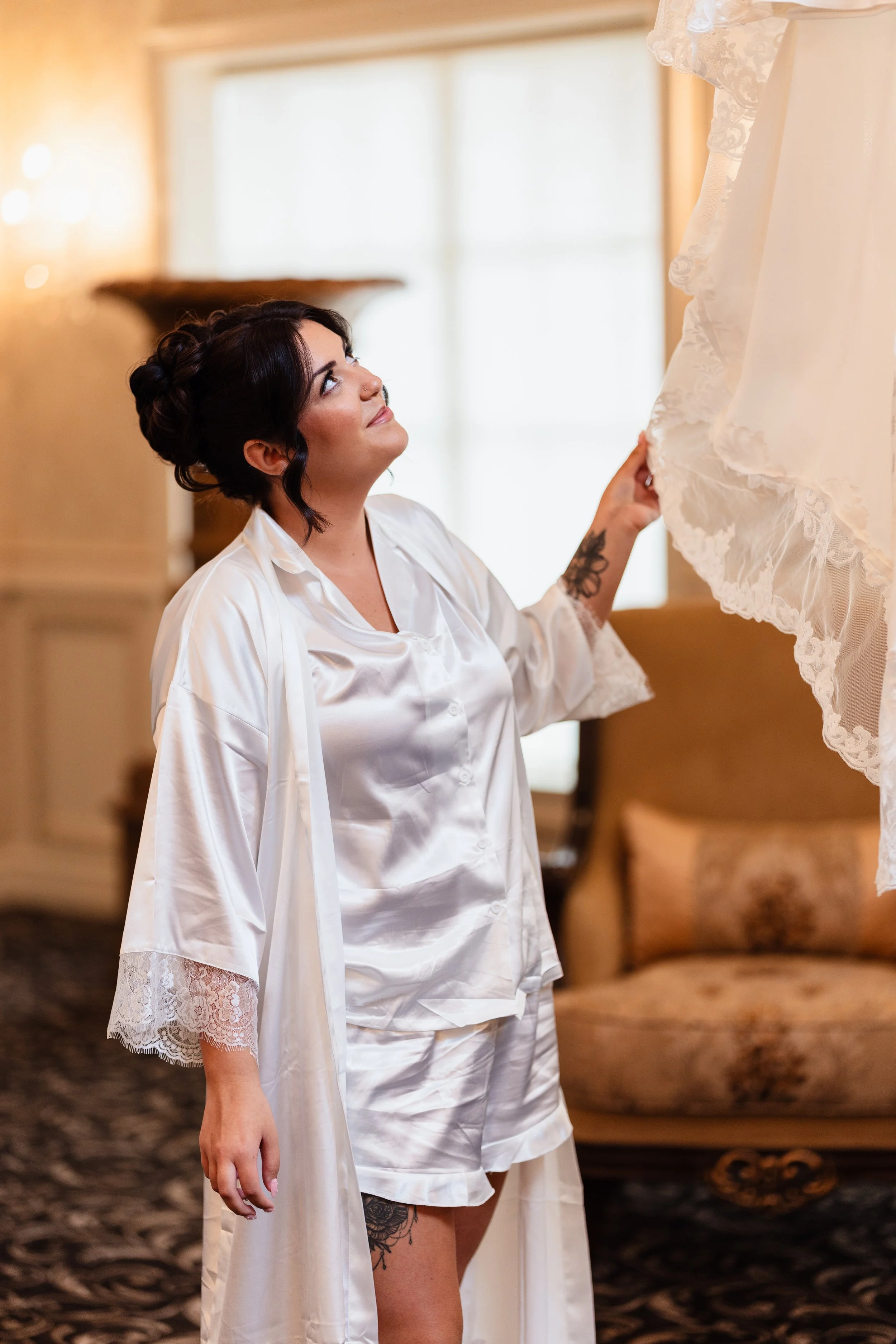 Bride admiring her dress during getting photos at Brigalias in Sicklerville New Jersey.