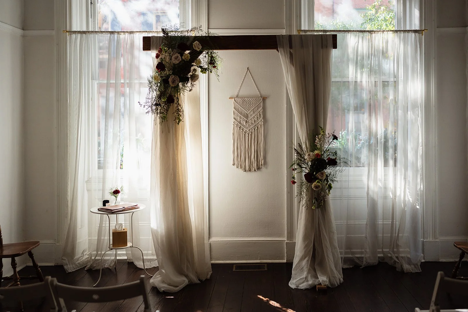 Ceremony details of arch with flowers, at Vaux Studio, in Philadelphia, PA. 