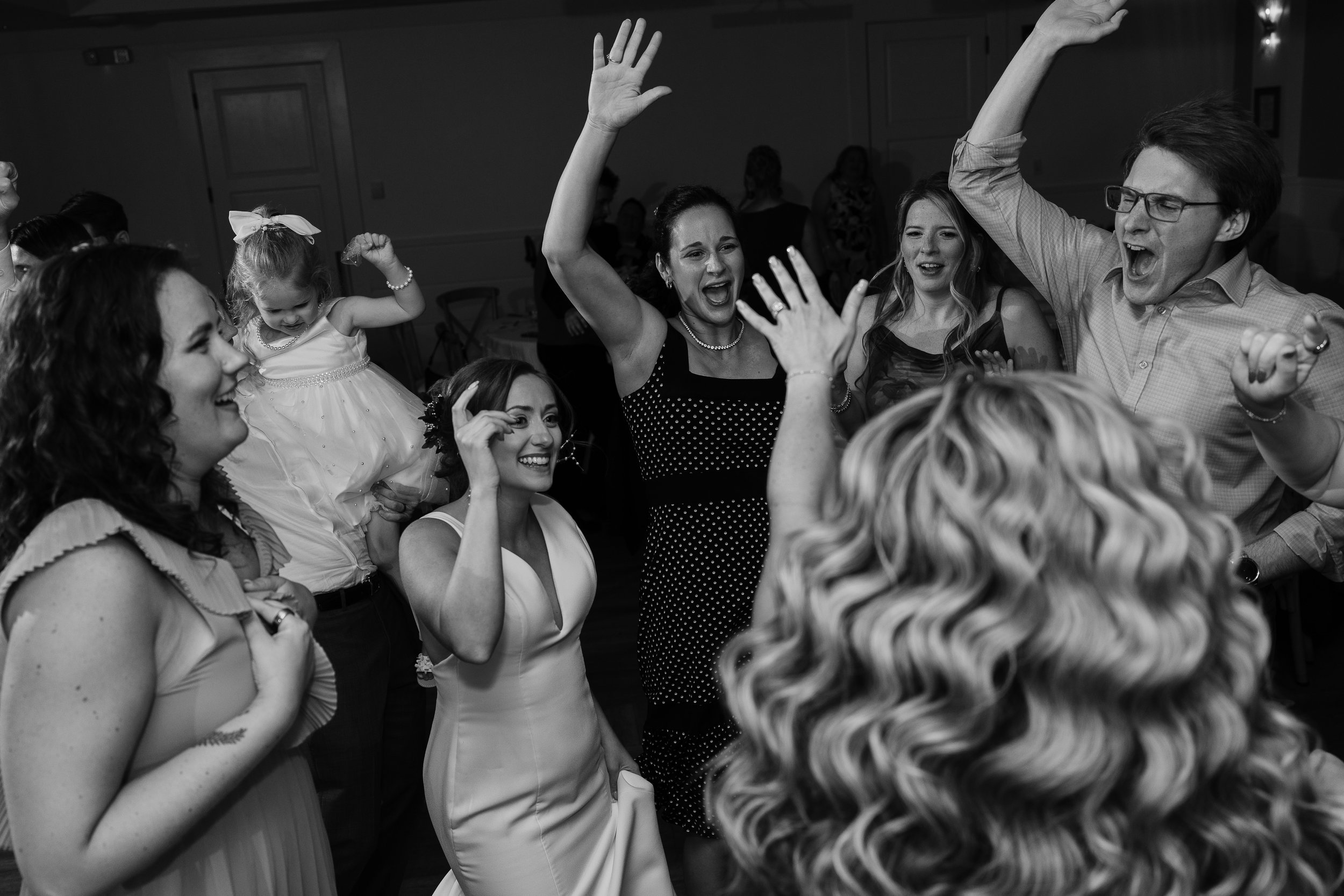Bride dancing with friends and family during wedding reception at The Reeds in Shelter Haven in Stone Harbor, New Jersey. 