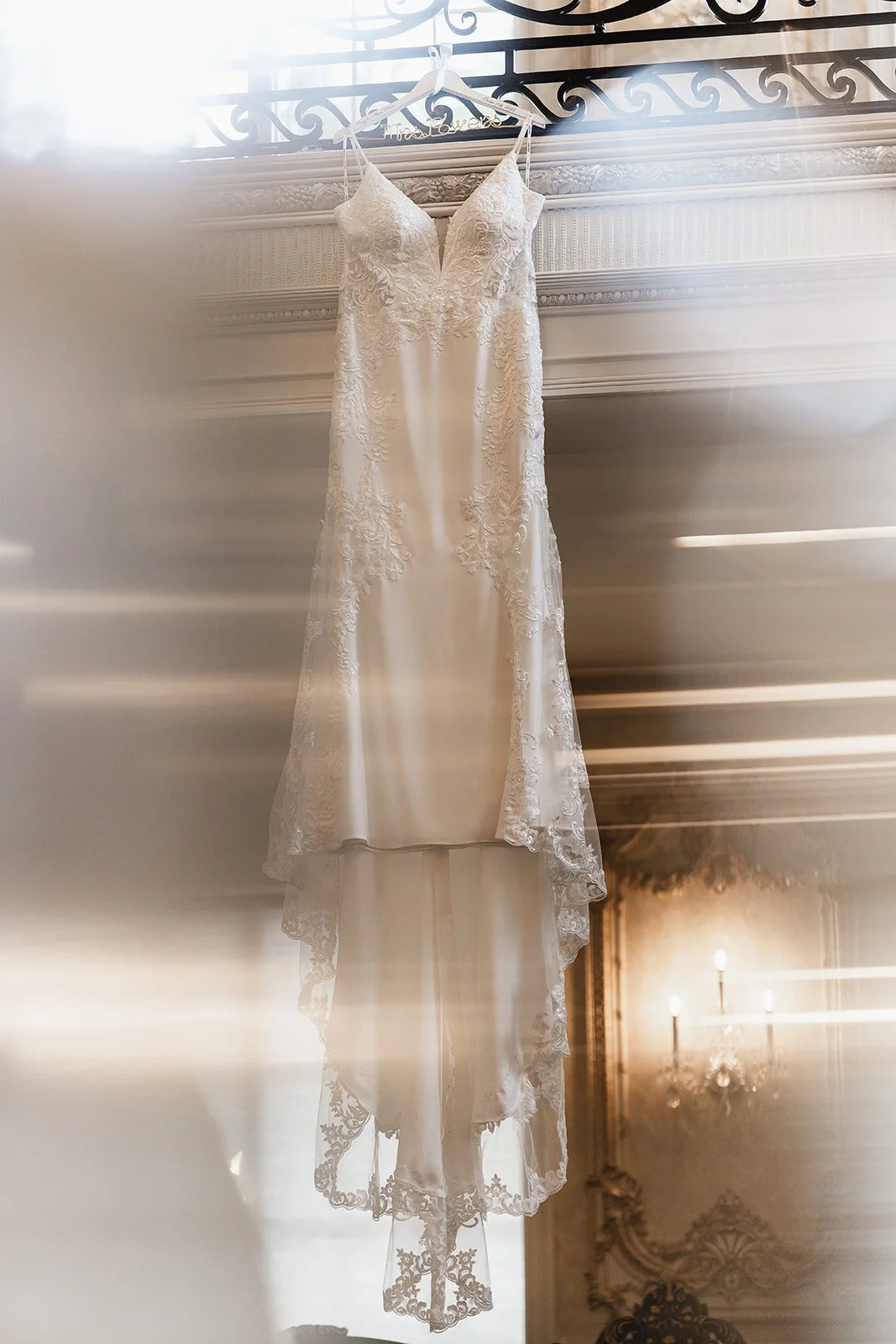 Wedding Dress hanging from railing with beautiful bokeh at Brigalias in Sicklerville New Jersey. 