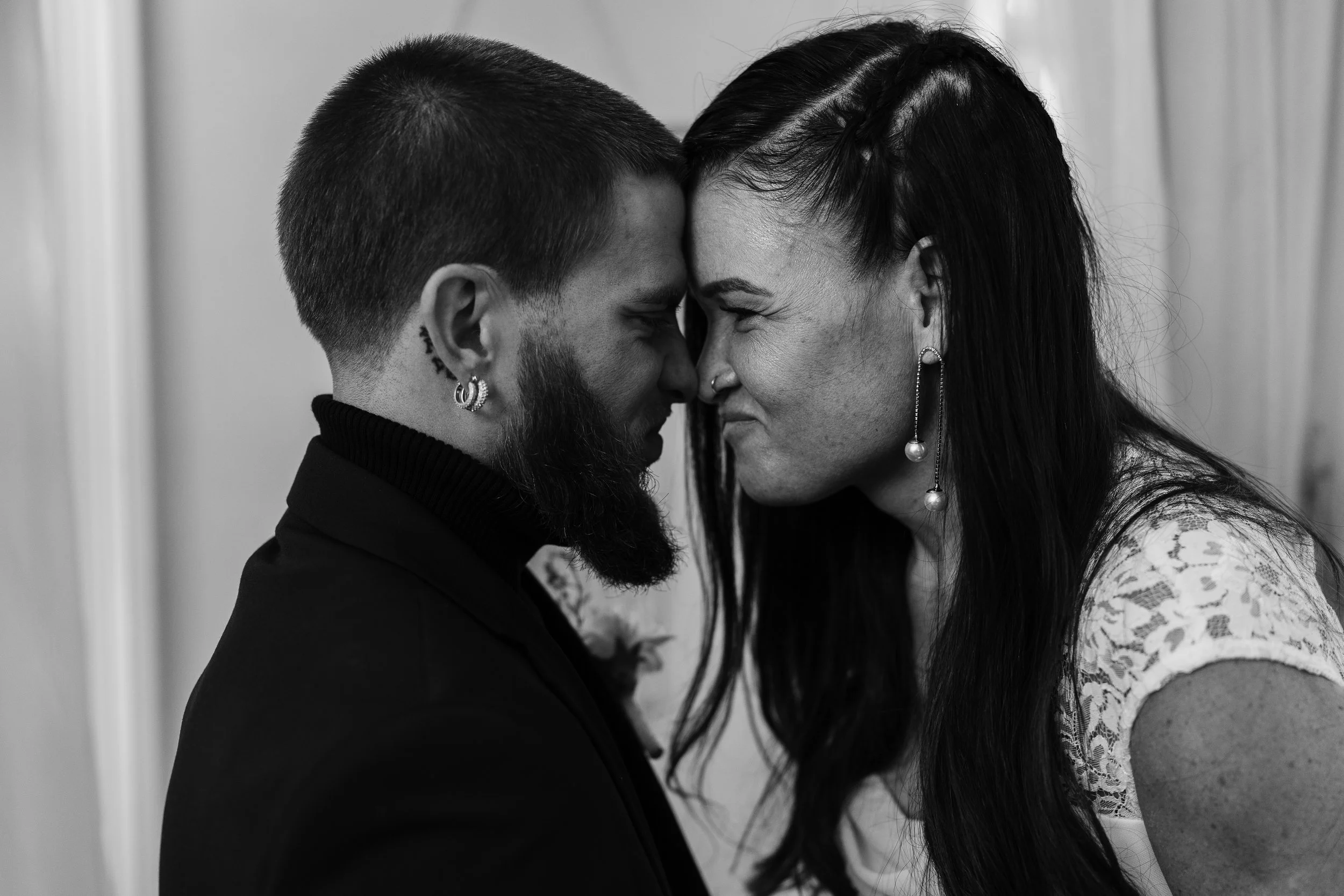 Bride and Groom touching foreheads during a shared moment post ceremony at Vaux Studio in Philadelphia, PA. 