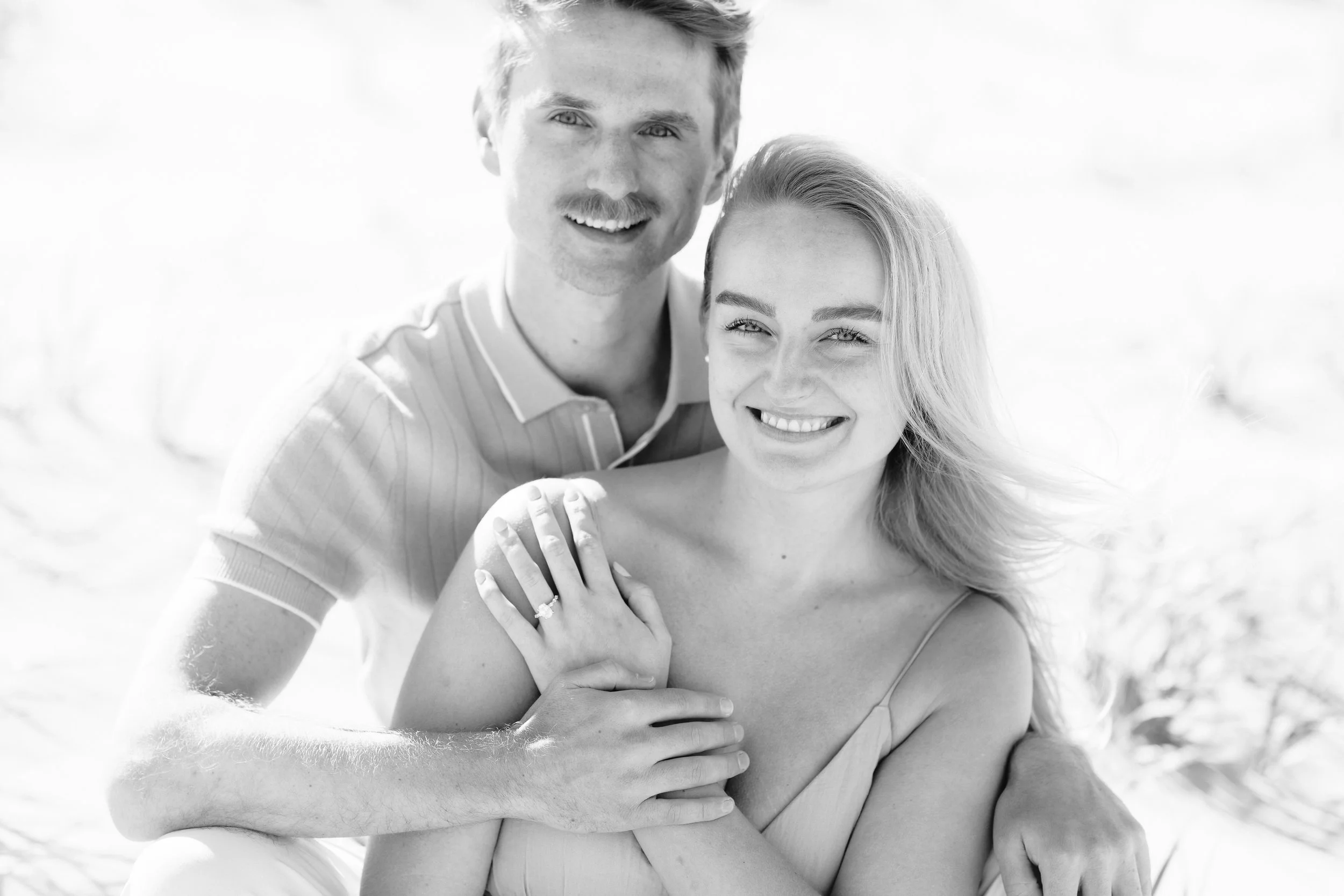 Couple tightly framed and posed during proposal photoshoot on the beach in Long Beach Island, NJ.