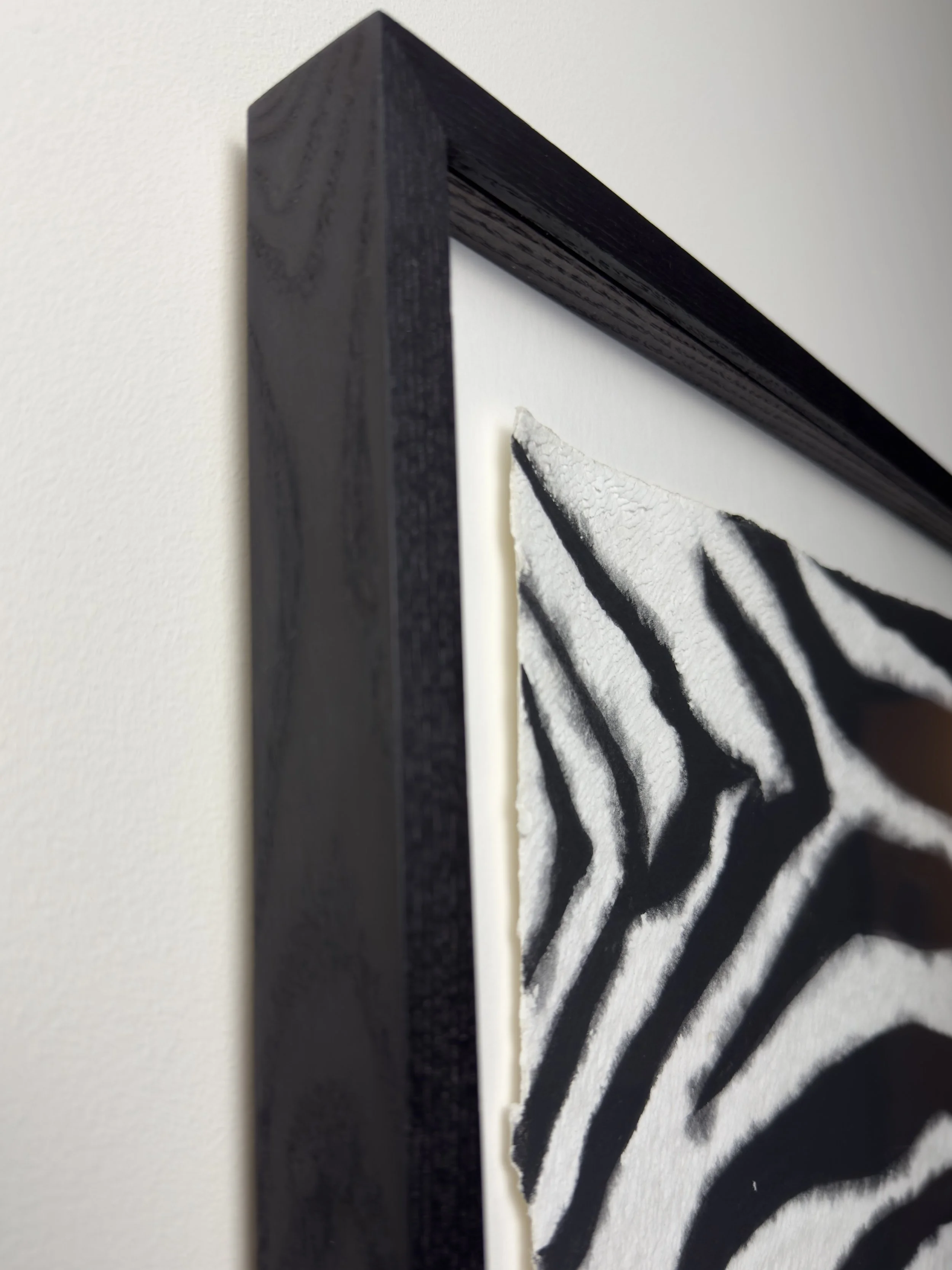 corner detail of bespoke black stained ash frame and zebra print original textured artwork