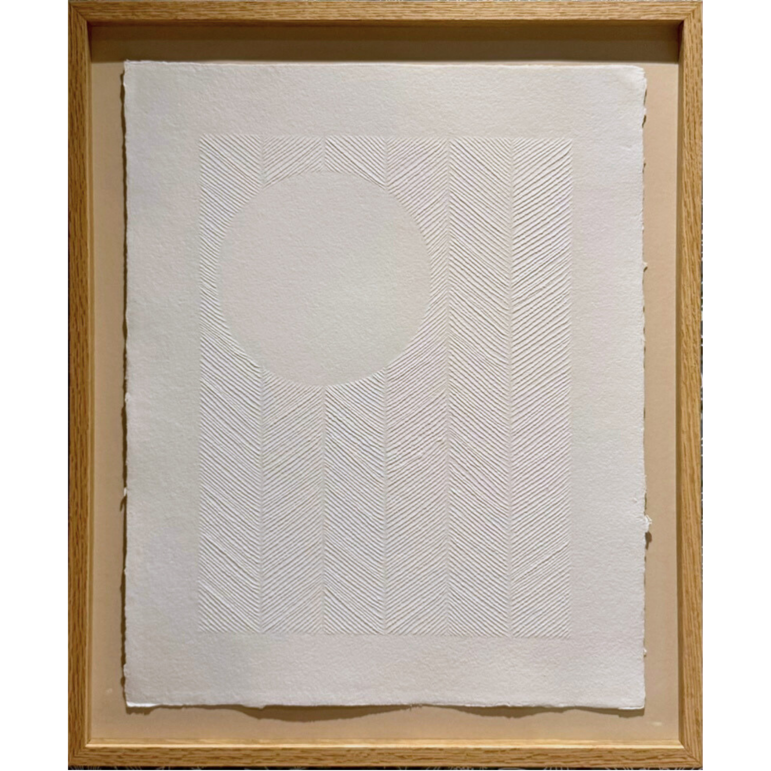 textured white artwork on paper with carvings. The full moon in the sky with chevron pattern
