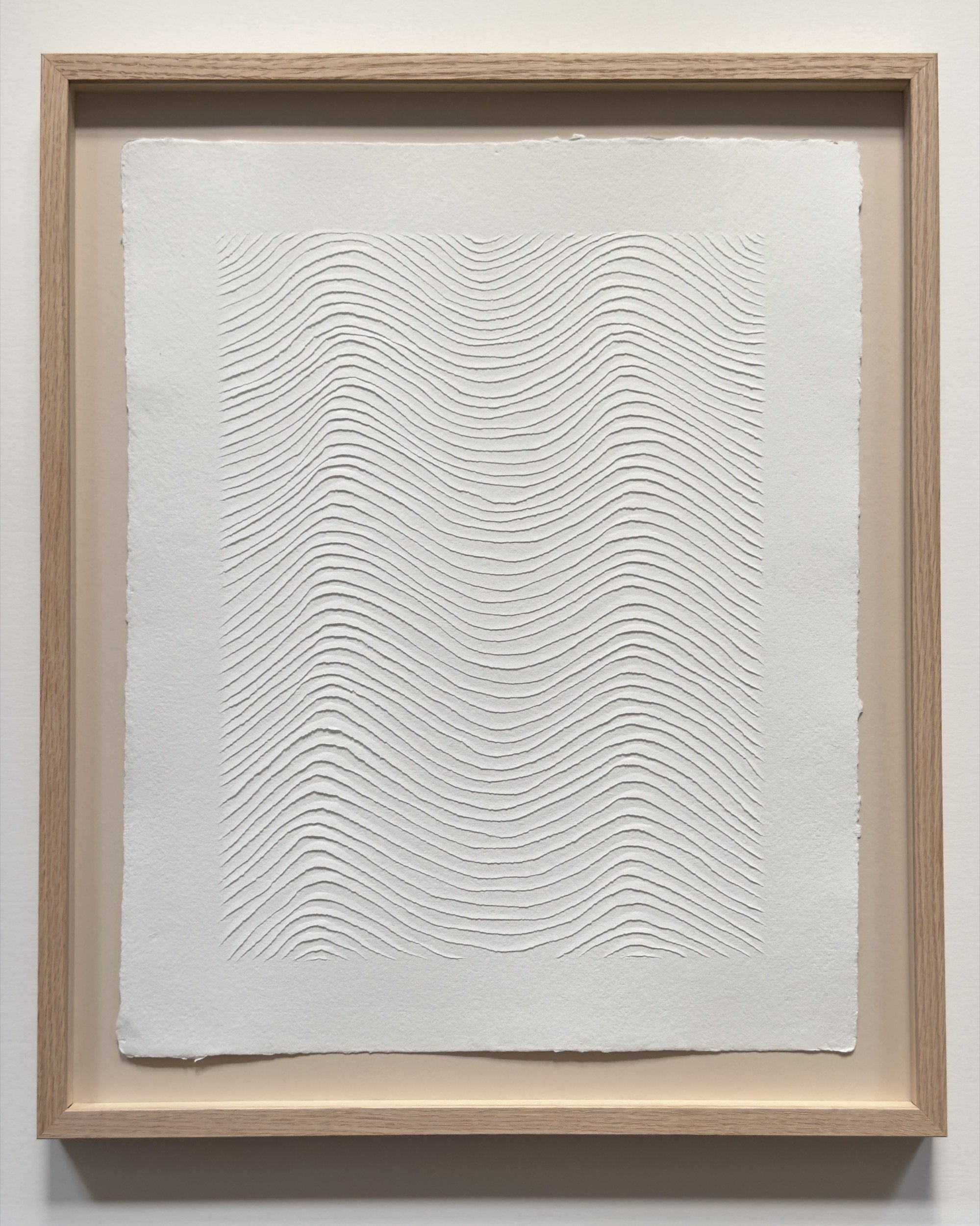 Repeated soft wave pattern carved into white cotton rag paper. Simplistic minimal textured original art.