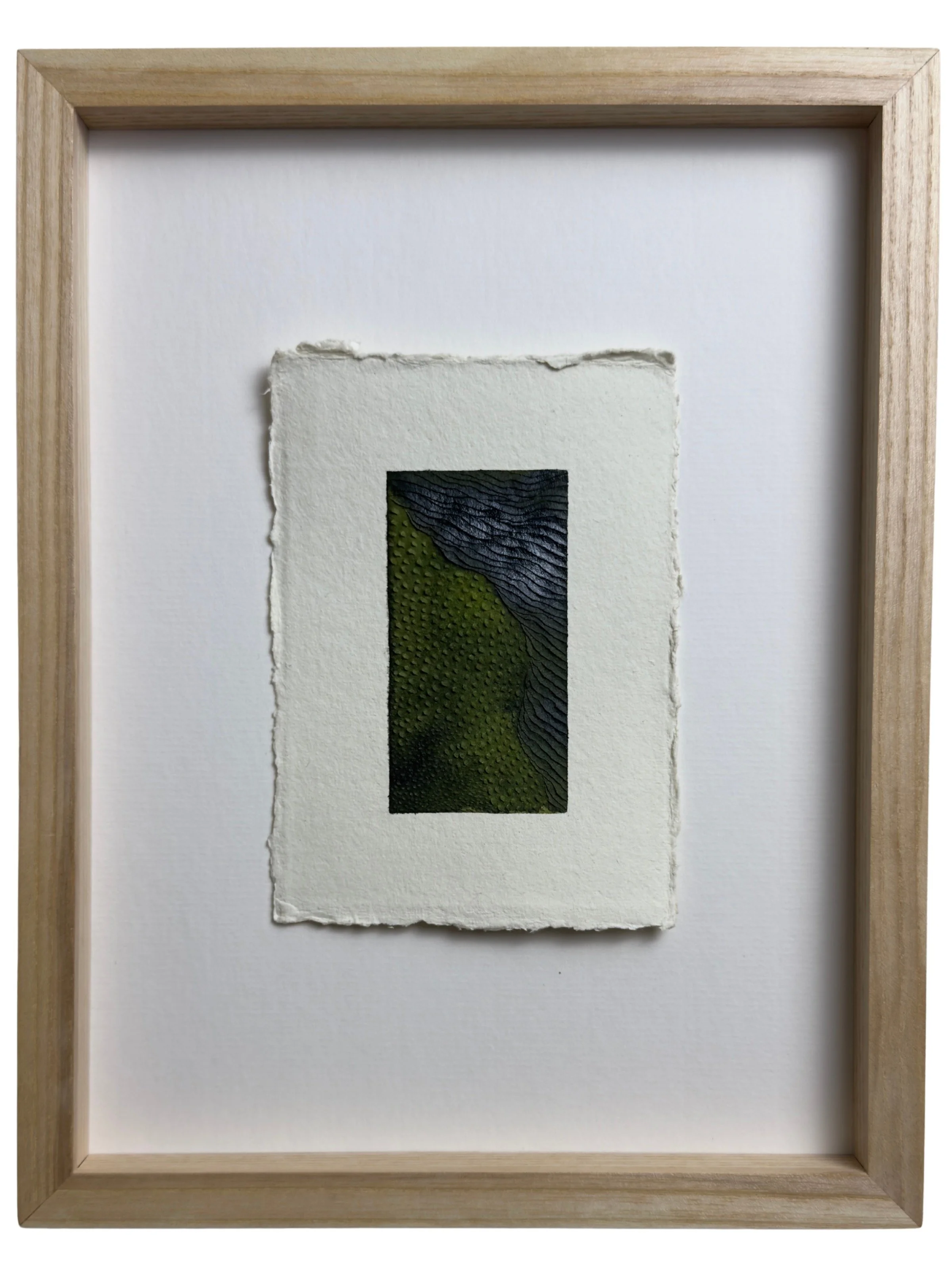 Small green artwork with textured carvings on paper with a wide mount, framed in ash wood