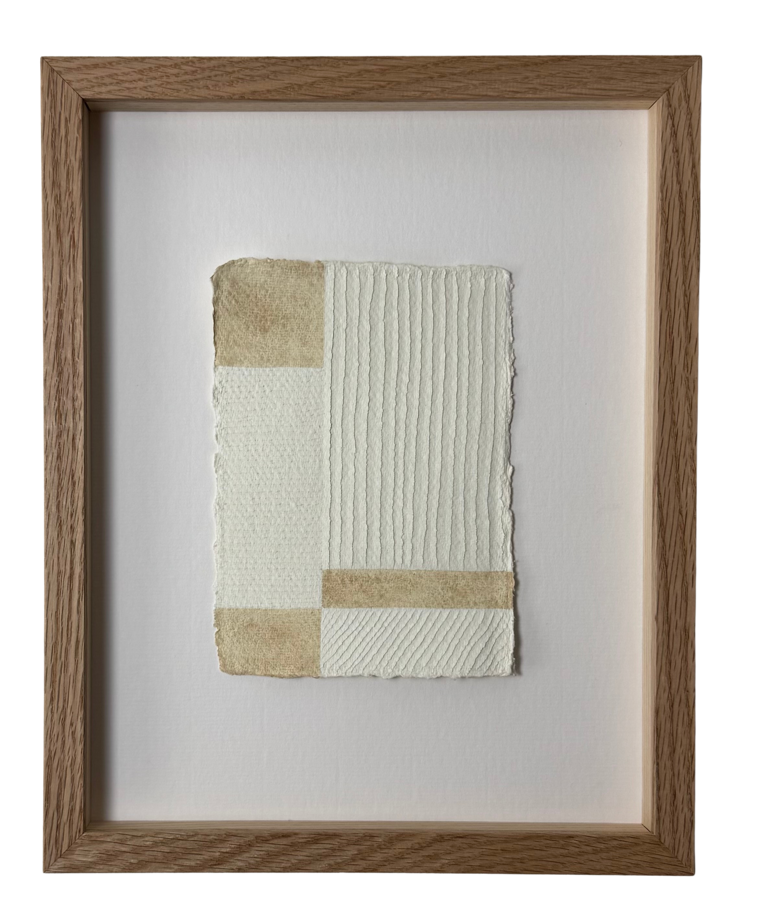 white and buff colour textural artwork on paper with carvings in a geometric block formation inspired by the work of Piet Mondrian. Framed in Oak with ArtGlass