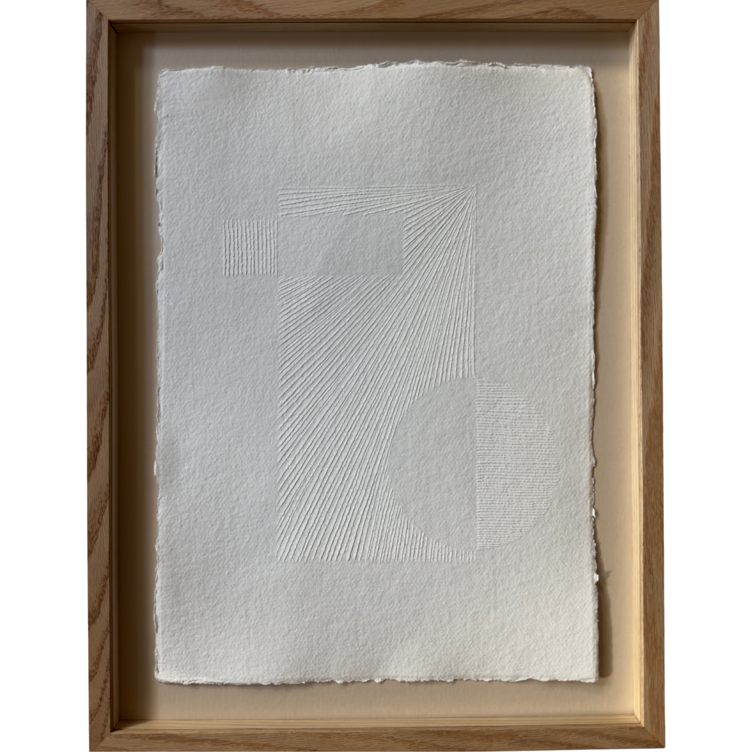 natural white cotton rag paper with surface carving creating a textured original artwork with geometric pattern. framed in oak with ArtGlass