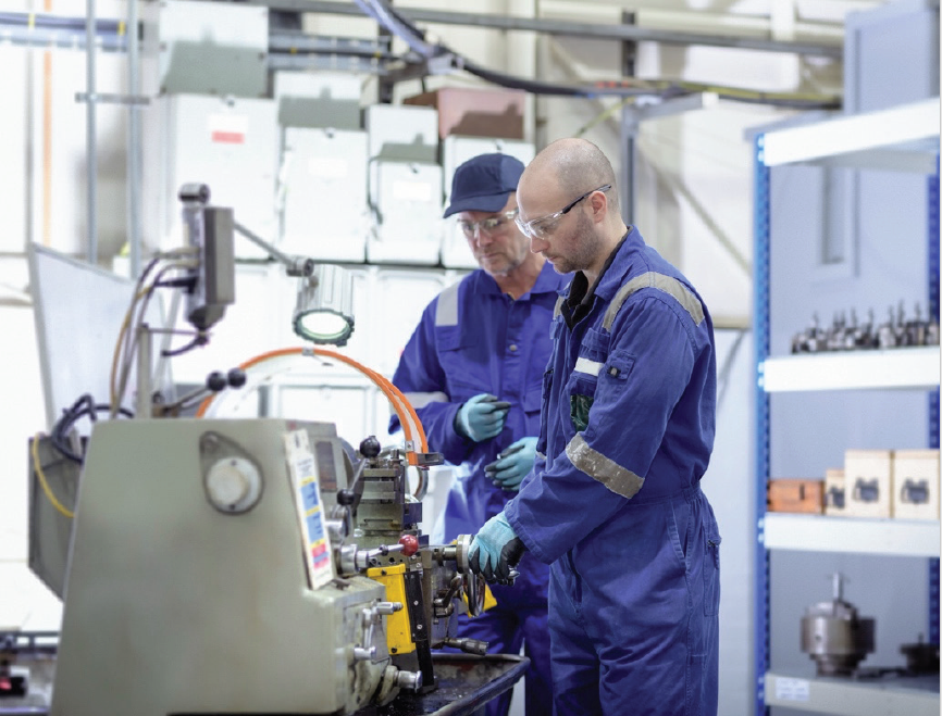 Workers looking at machinery