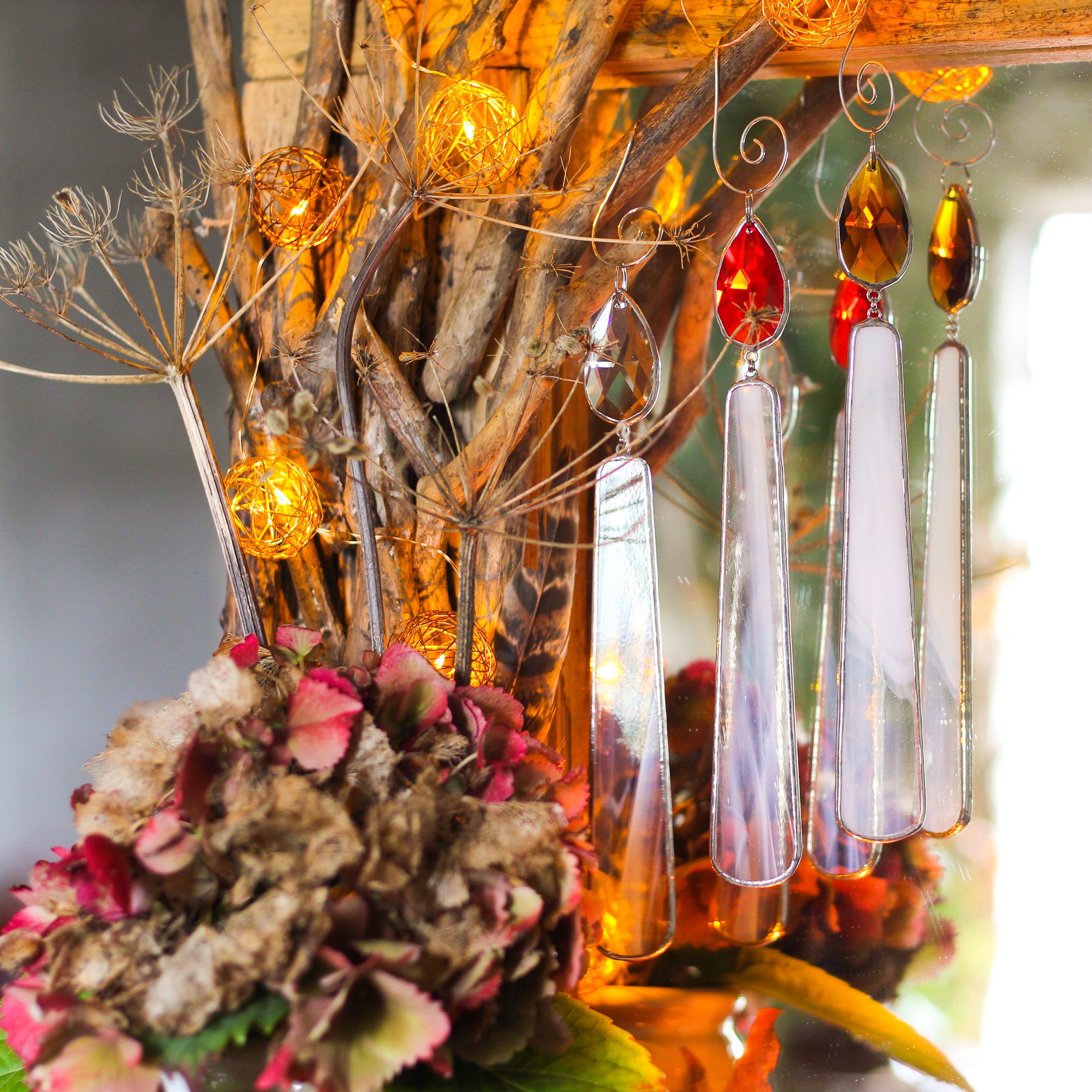 autumnal decor idea featuring 3 handcrafted stained glass candles reflected in a mirror