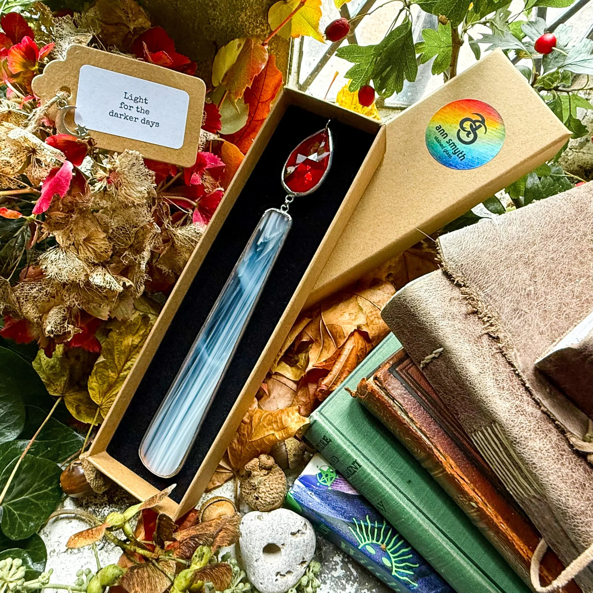 Stained glass candle with red crystal flame presented in luxury Kraft gift box.