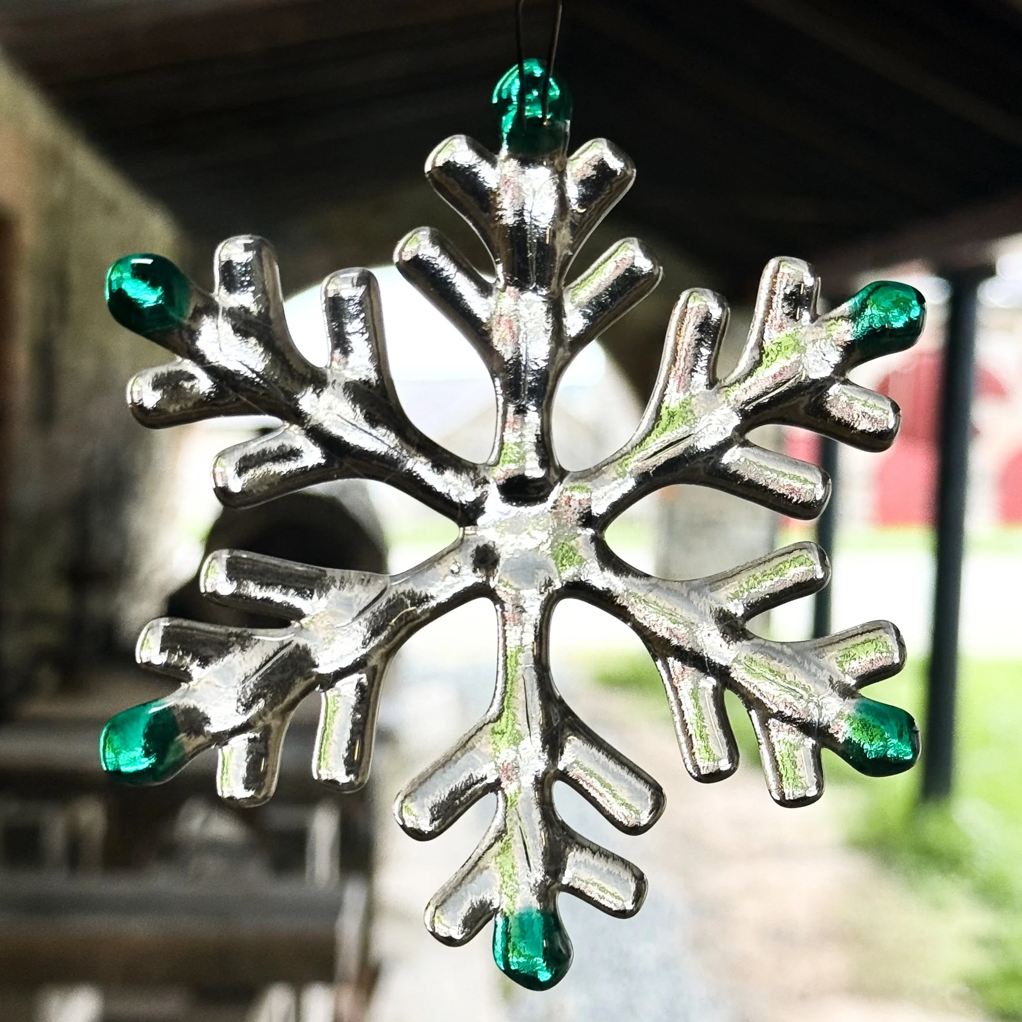 Kiln formed glass snowflake photographed in natural light. Ann Smyth Stained Glass
