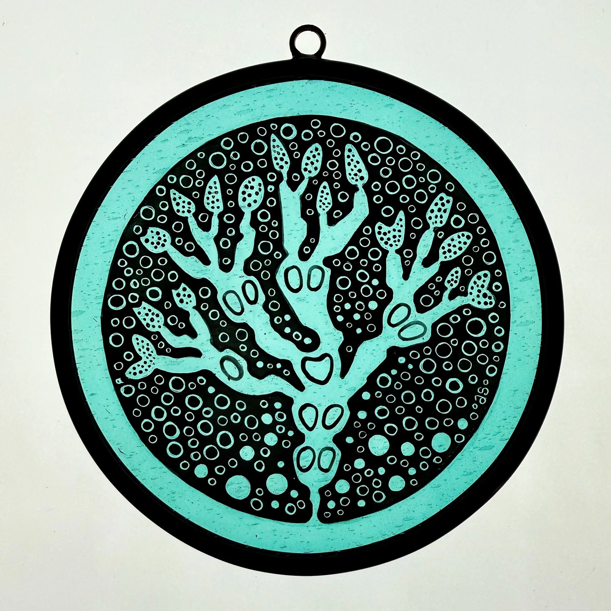 Hand painted Irish stained glass roundel featuring native Bladderwrack seaweed, kiln fired using traditional leaded glass techniques