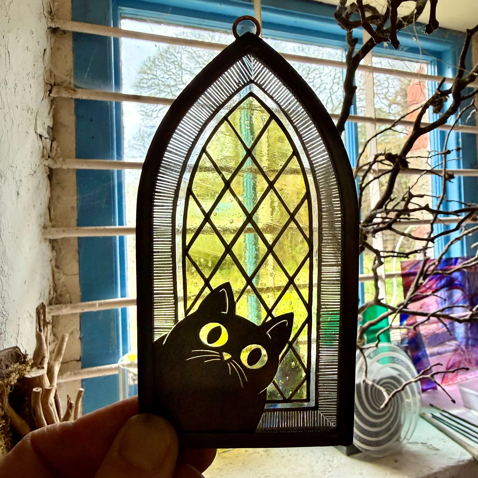 Church cat stained glass window hanging photographed in studio