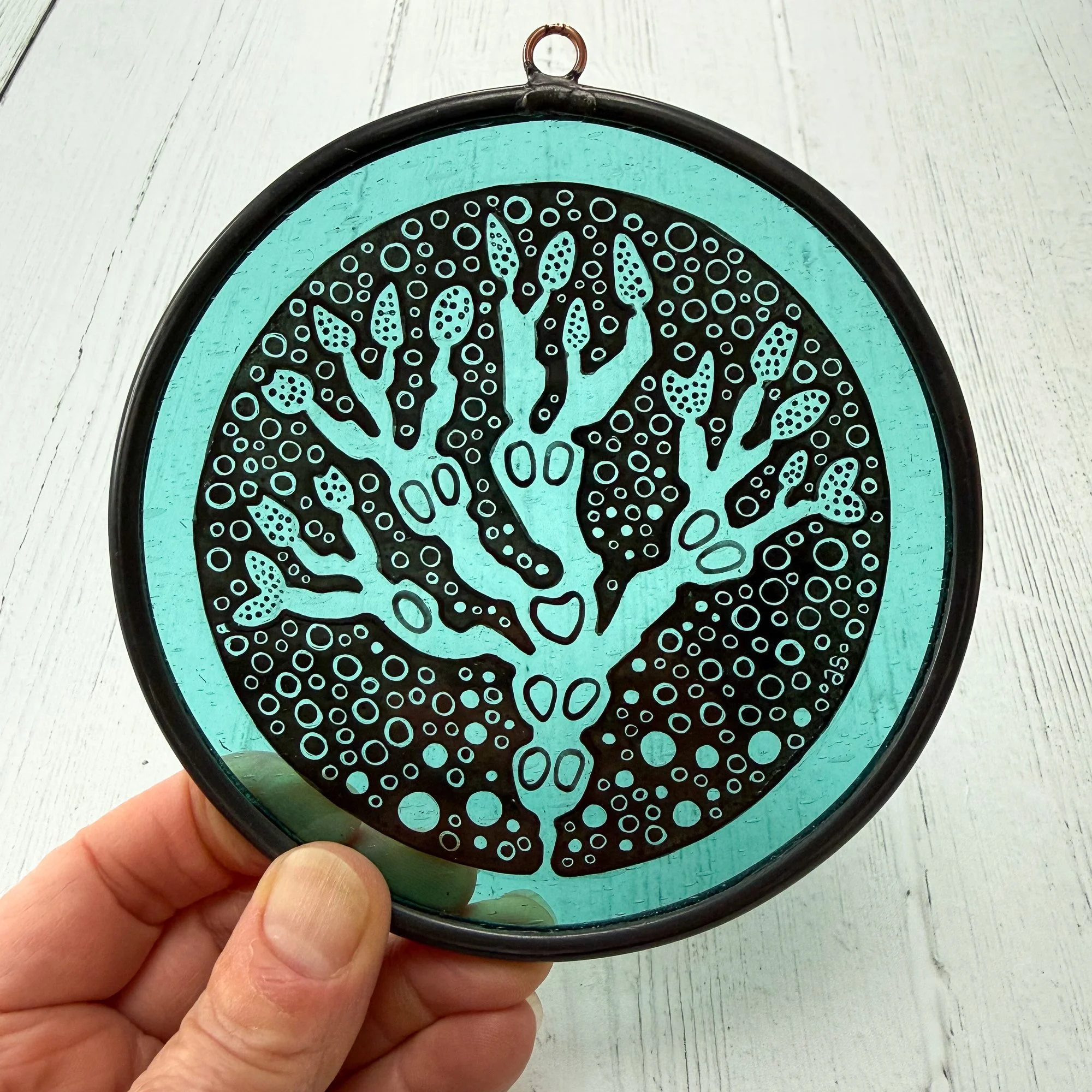 Irish bladderwrack seaweed hand painted on mouth blown antique glass pictured with hand to show scale