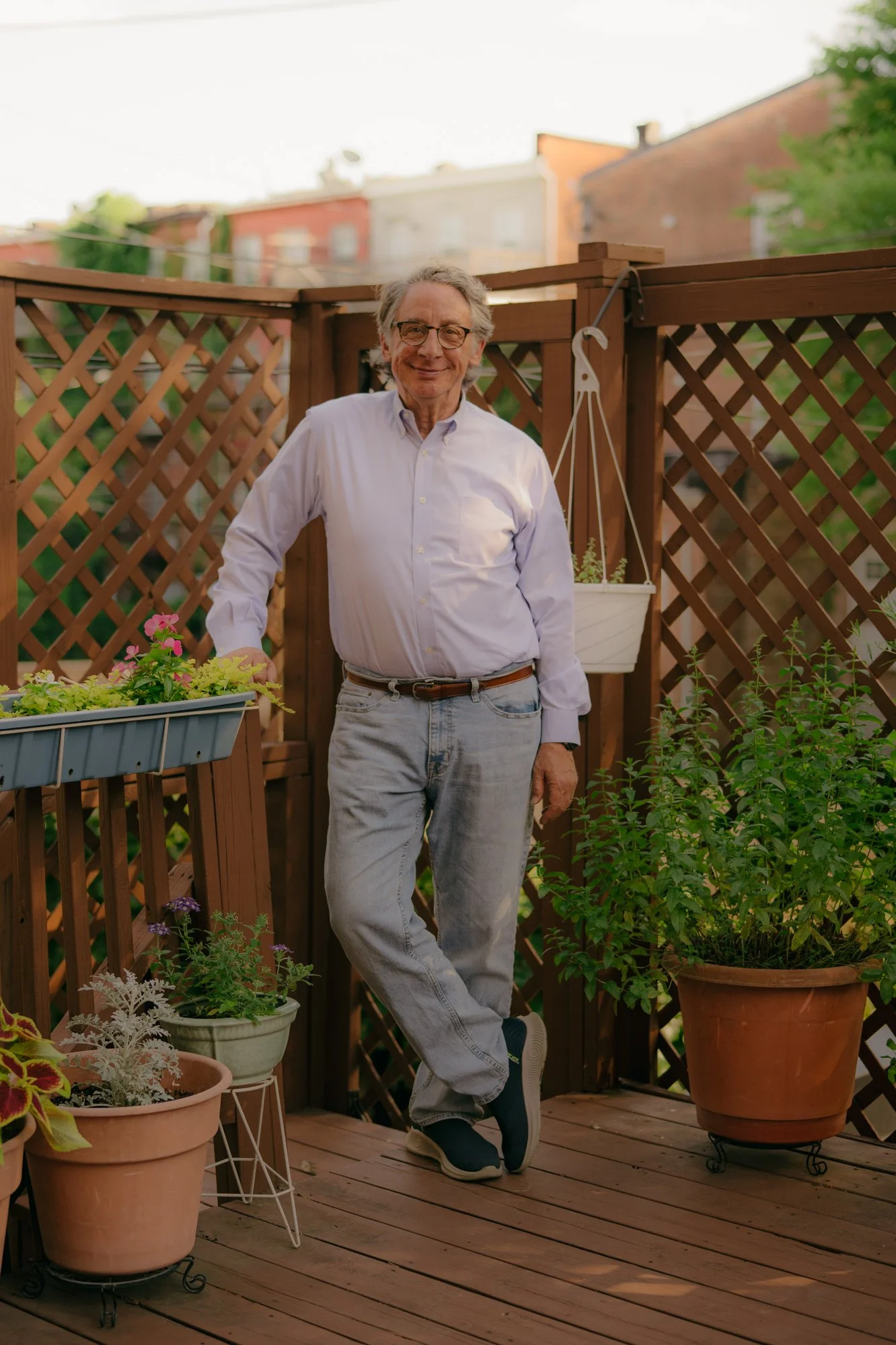 Tom Hall, Senior News Analyst at WYPR Radio and Music Director Emeritus of Baltimore Choral Arts, poses for a portrait on his back porch in Baltimore, Md. on June 19, 2026.