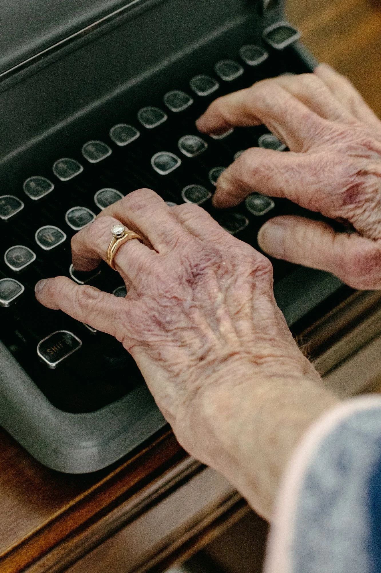 Betty Connors, my grandmother, types on an old typewriter at her home in Raleigh, N.C. on April 21, 2022. Connors is gradually packing up her things — many of which she plans to give away — in preparation for a move to a retirement home.