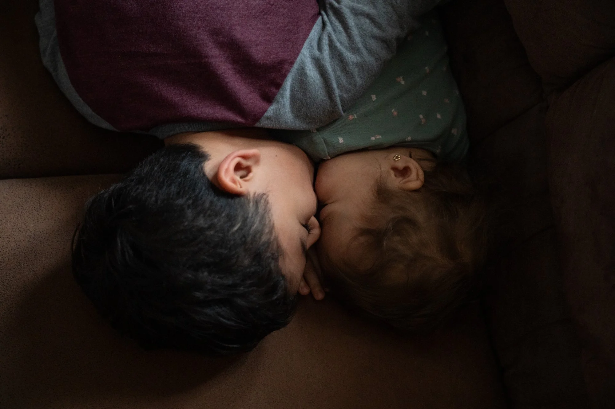 Jacob, 5, gives his sister Gianna, 2, a kiss on the cheek while she naps on the couch on Thursday, Jan. 22, 2026 in Hicksville, N.Y. Jacob and Gianna lived without their mother, Stephanie, and older sister Ariana, 14, for more than a month after the 