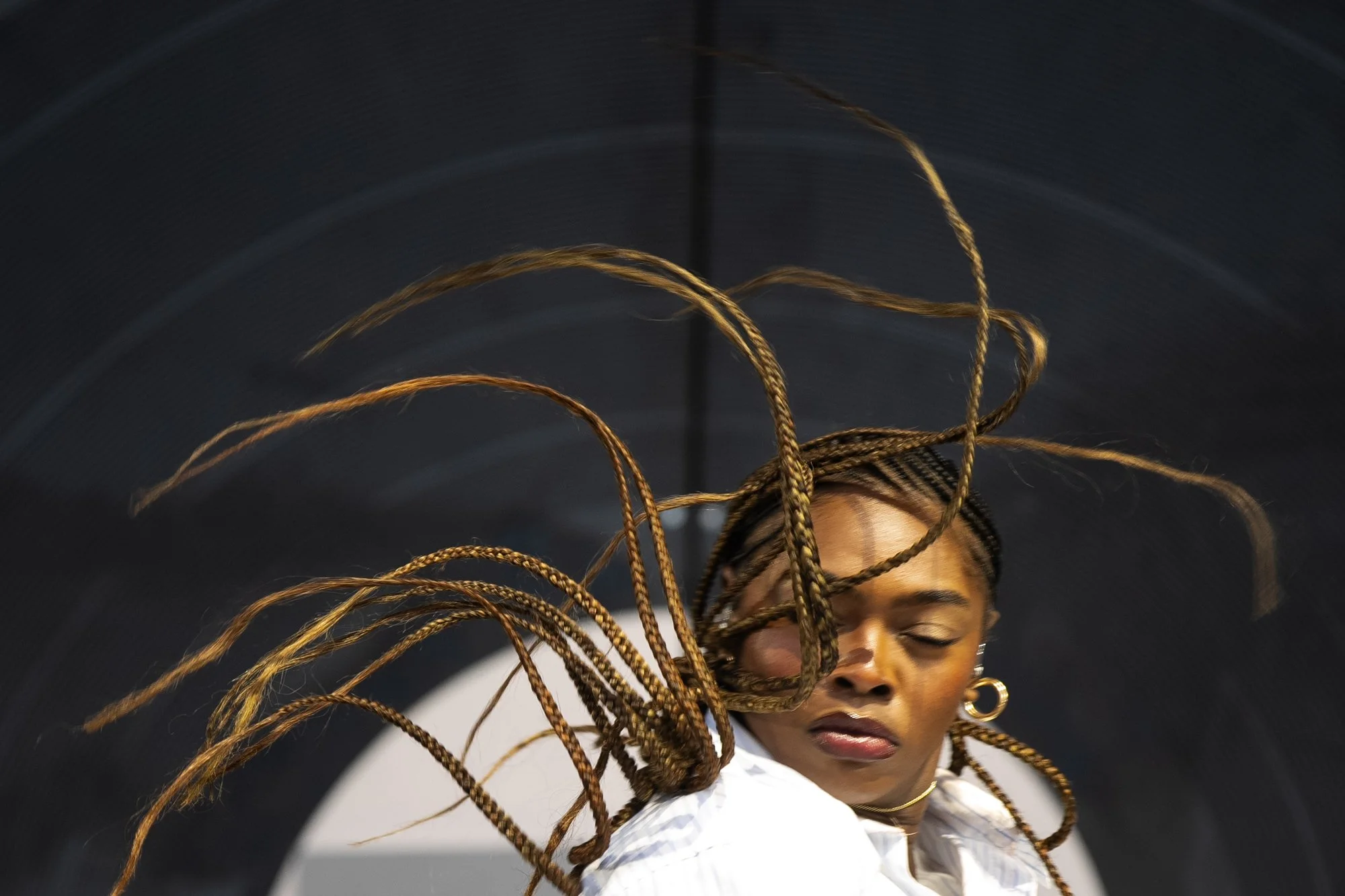 A backup dancer flips their hair during Doechii's performance at Outside Lands Music Festival in San Francisco, Calif. on Friday, Aug. 8, 2025.